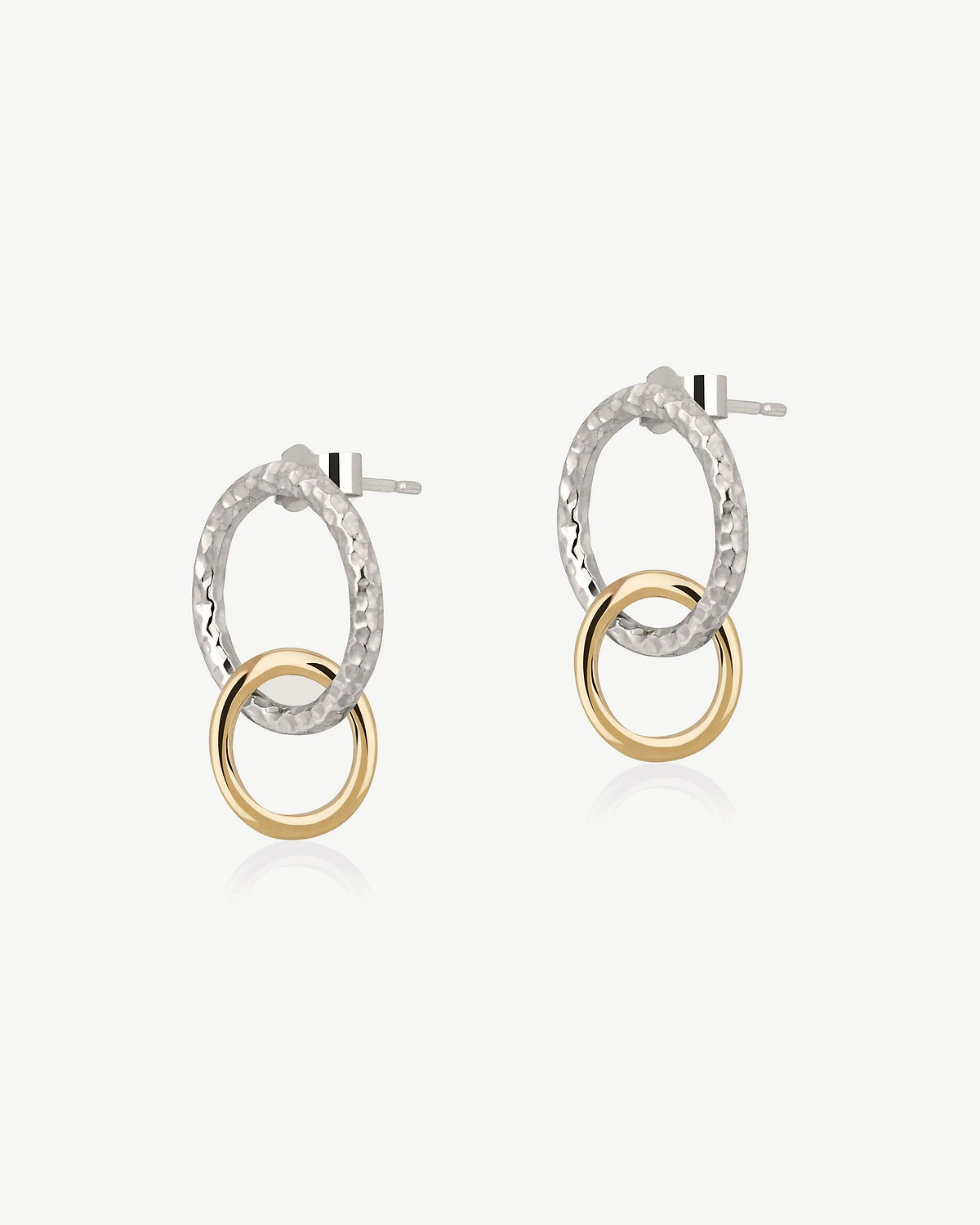 Pair of halo drop earrings with hammered sterling silver ovals and gold rings.
