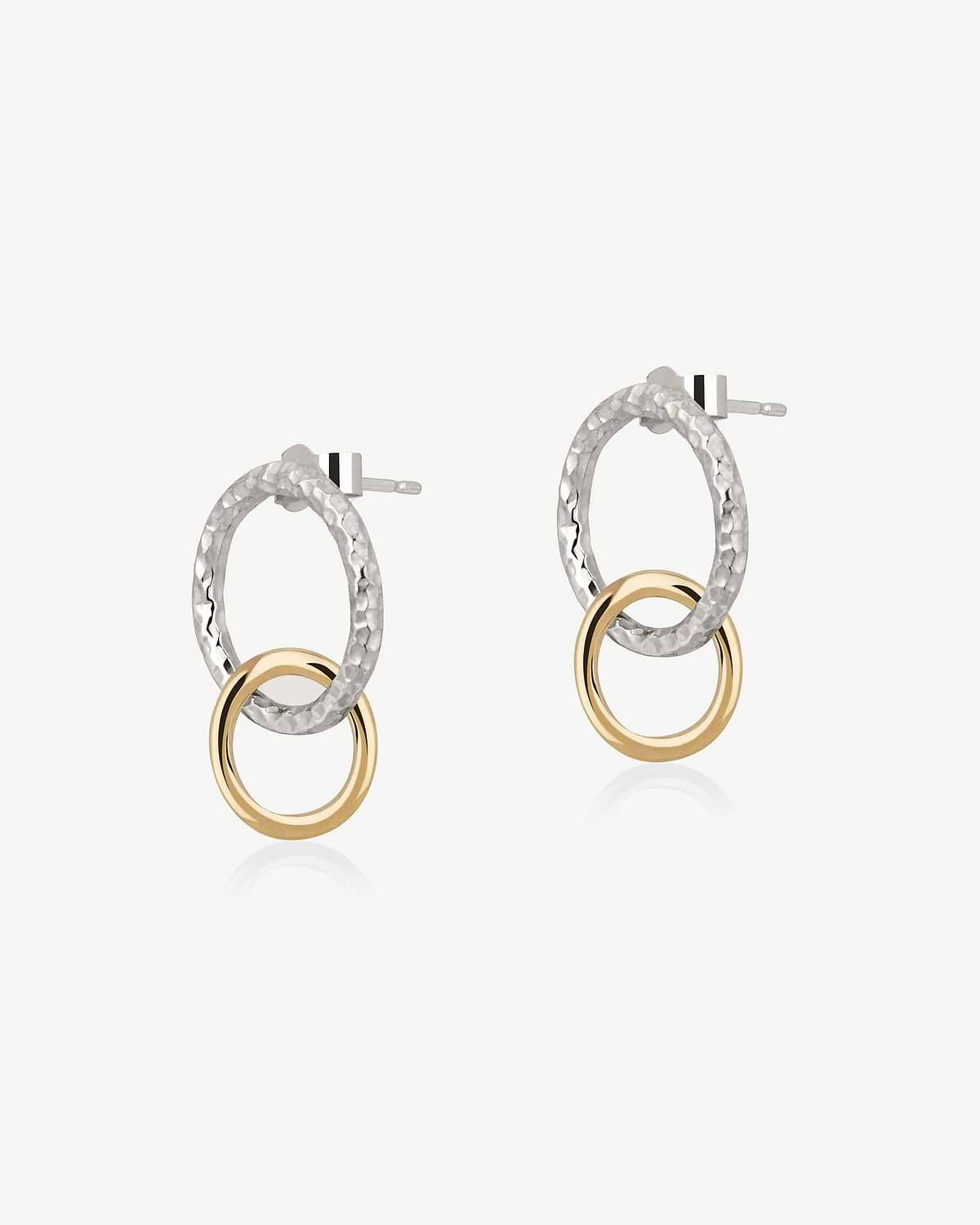 Pair of halo drop earrings with hammered sterling silver ovals and gold rings.