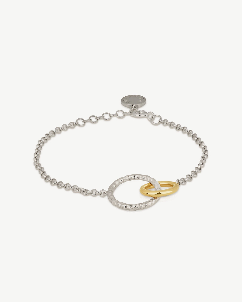 Sterling silver chain bracelet with a hammered silver ring and a gold-gilded ring.