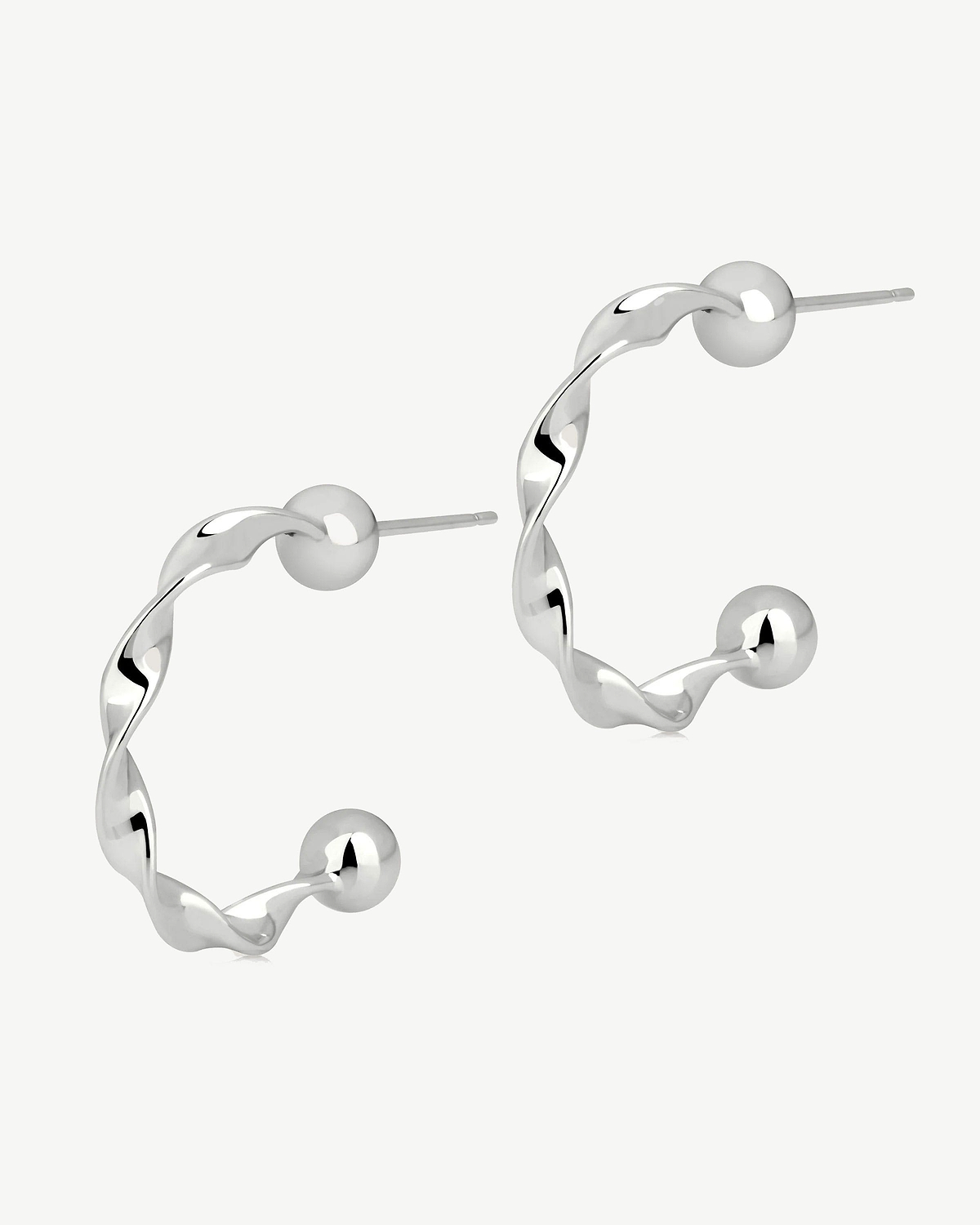 Pair of sterling silver twisted crescent hoop earrings with ball end posts.