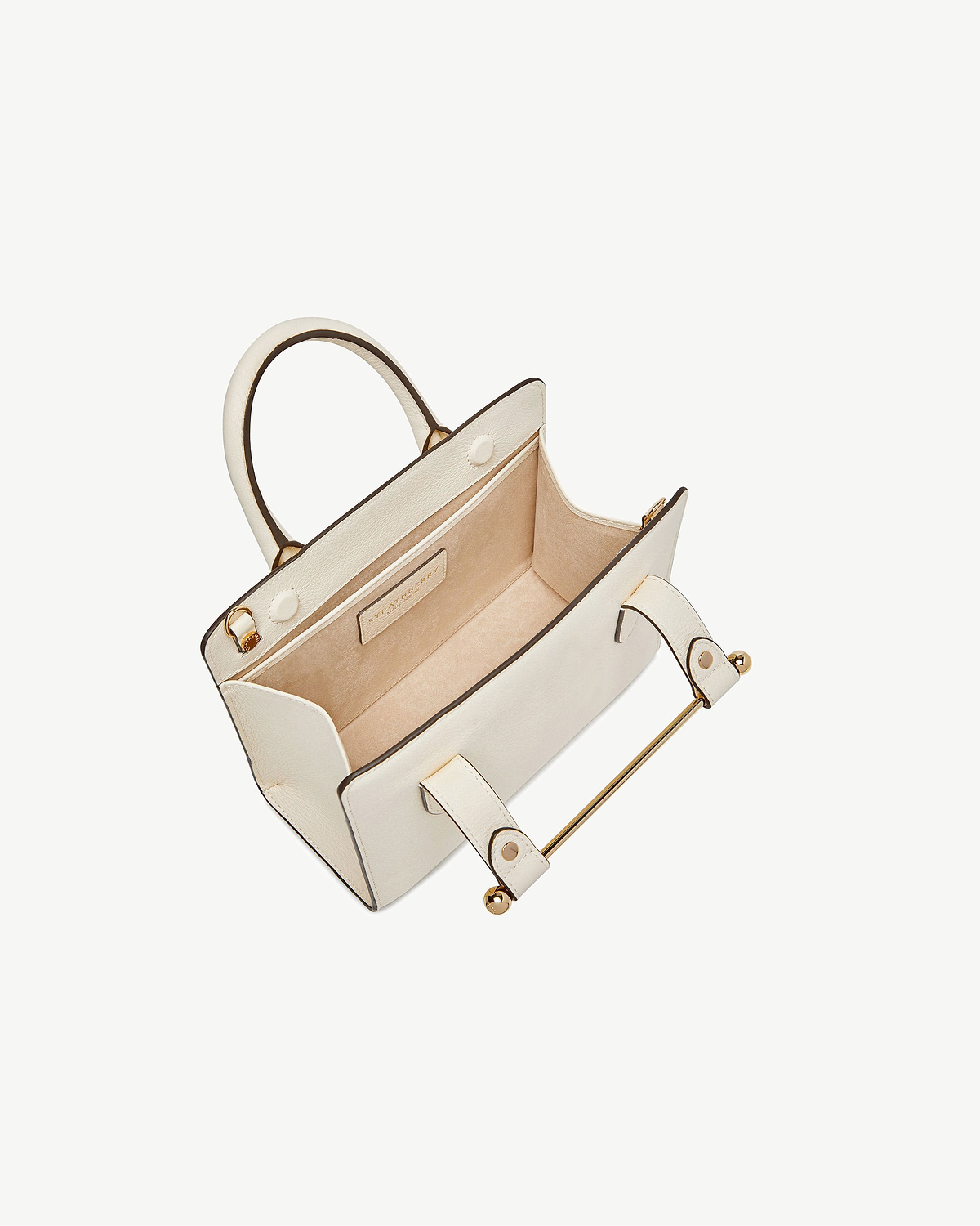Vanilla mini tote with open top showing suede interior and gold hardware.