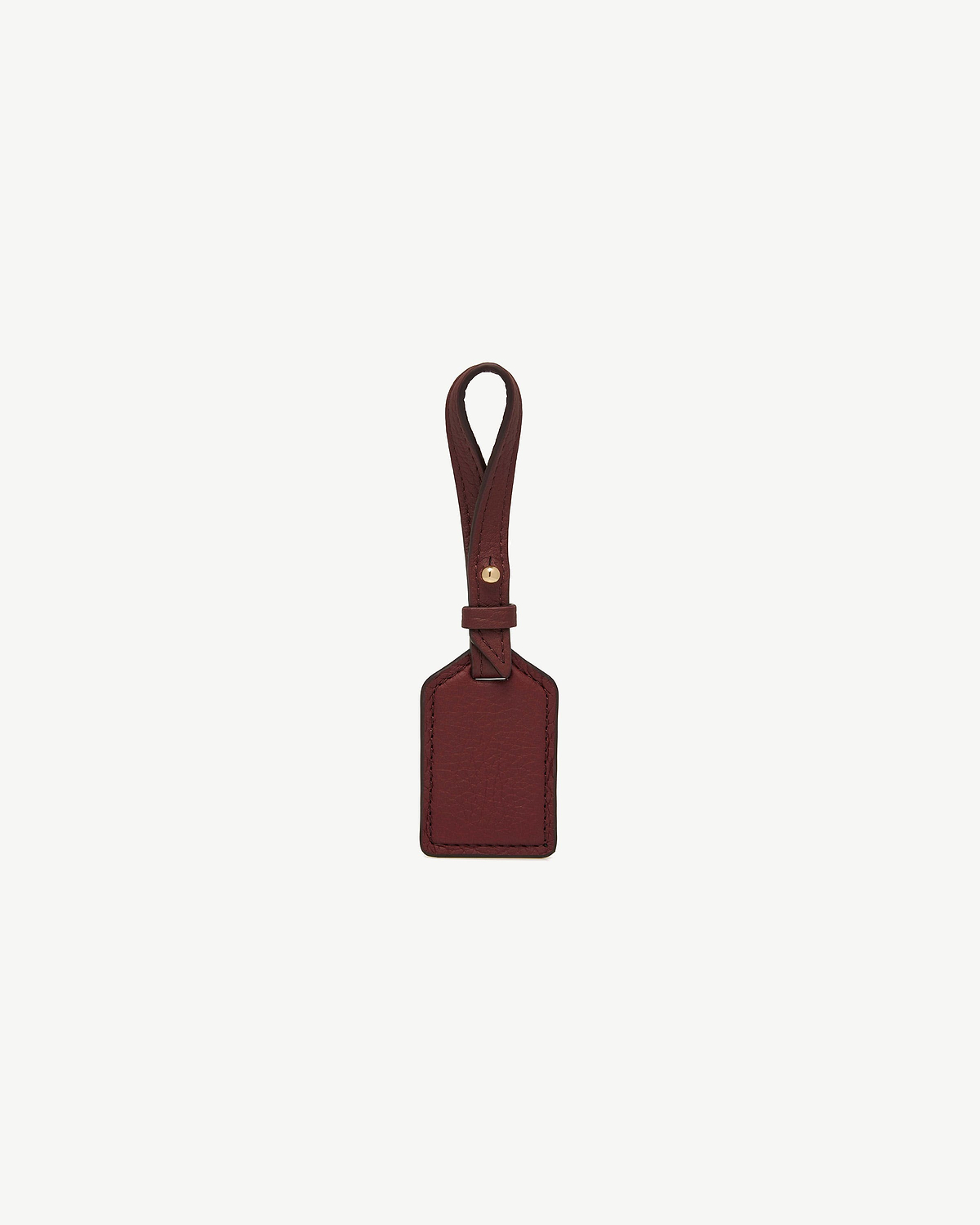 Oxblood leather tag with loop strap, rectangular panel, and gold-tone stud.