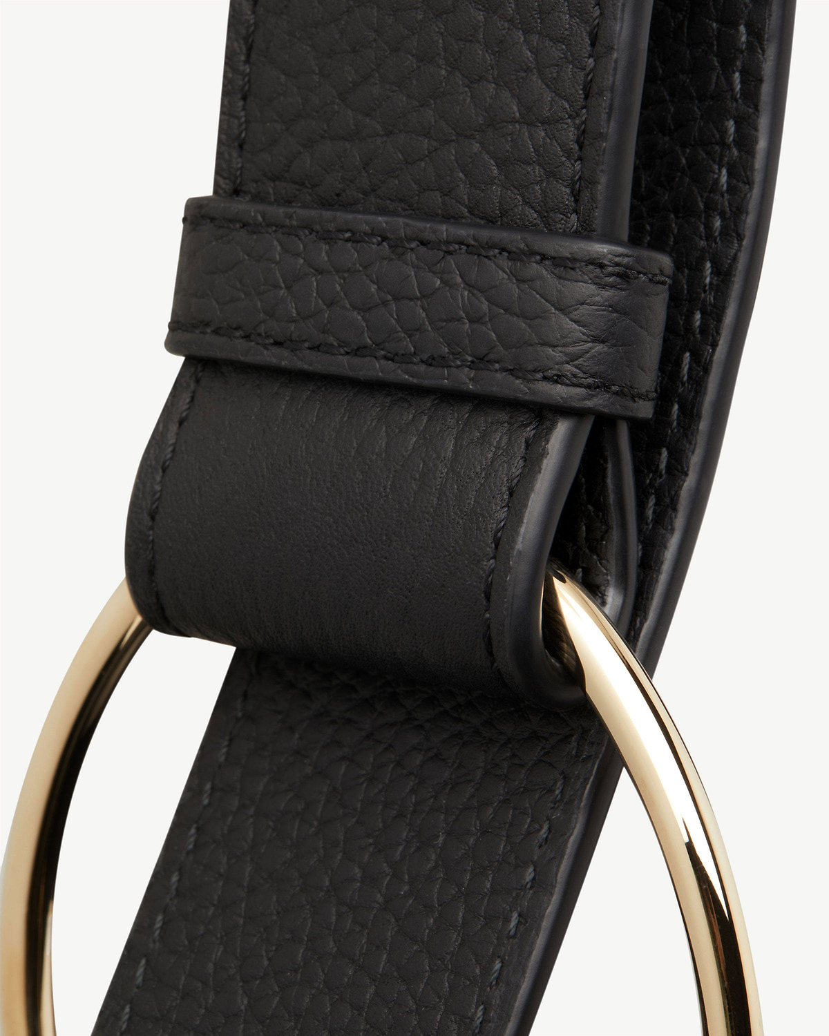 Black pebbled leather strap with gold circular metal ring hardware