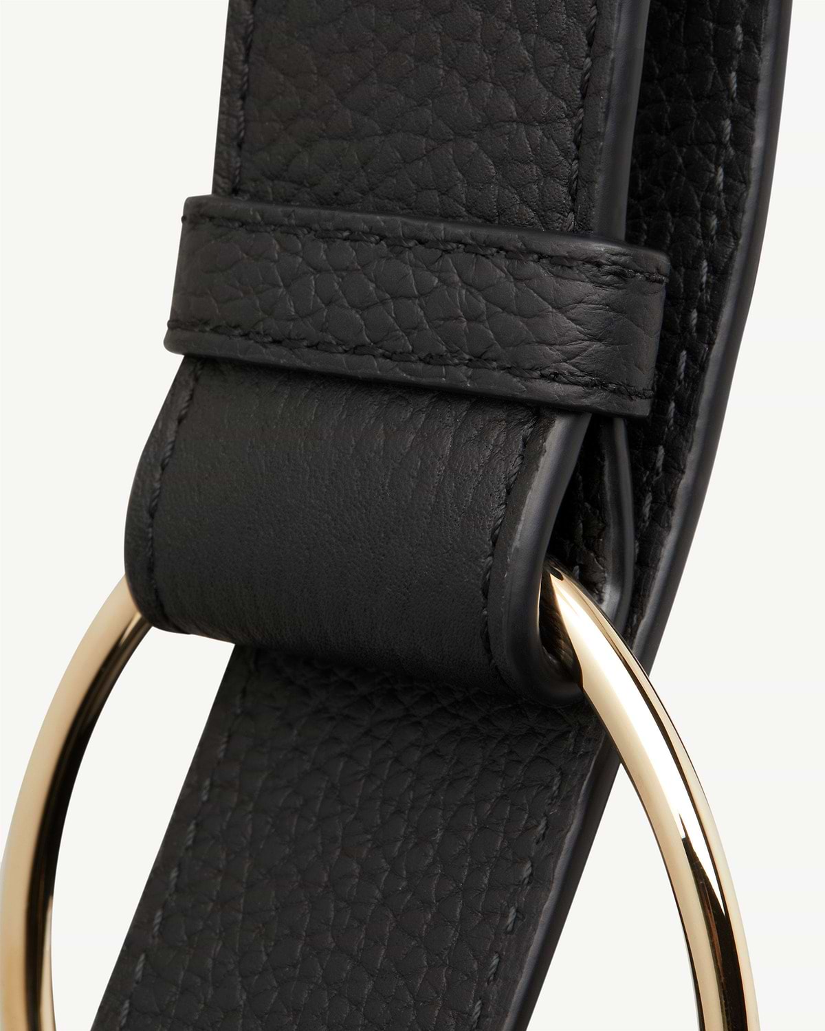 Black pebbled leather strap with gold circular metal ring hardware