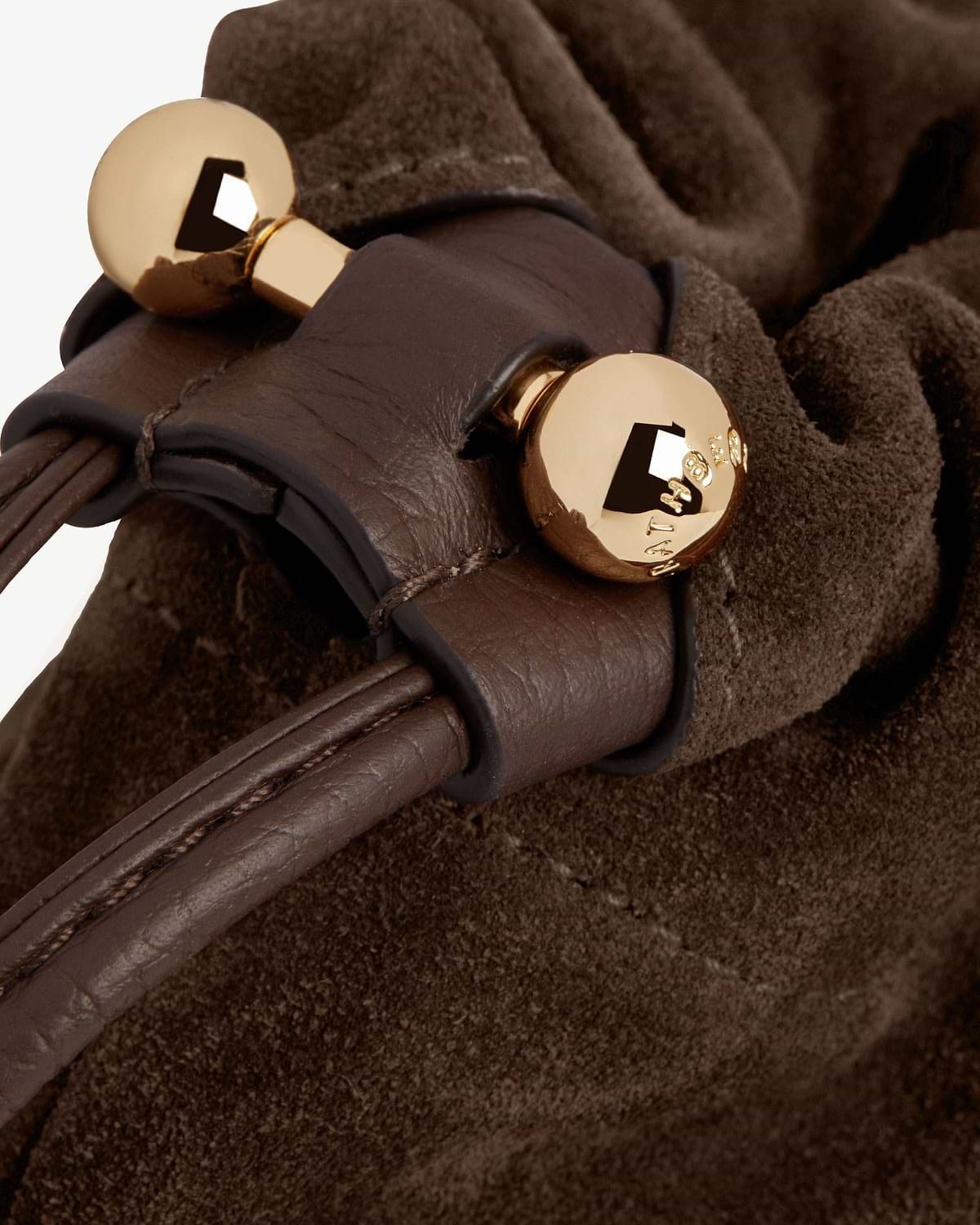 Chocolate suede drawstring bag with leather cord and gold ball toggle hardware.