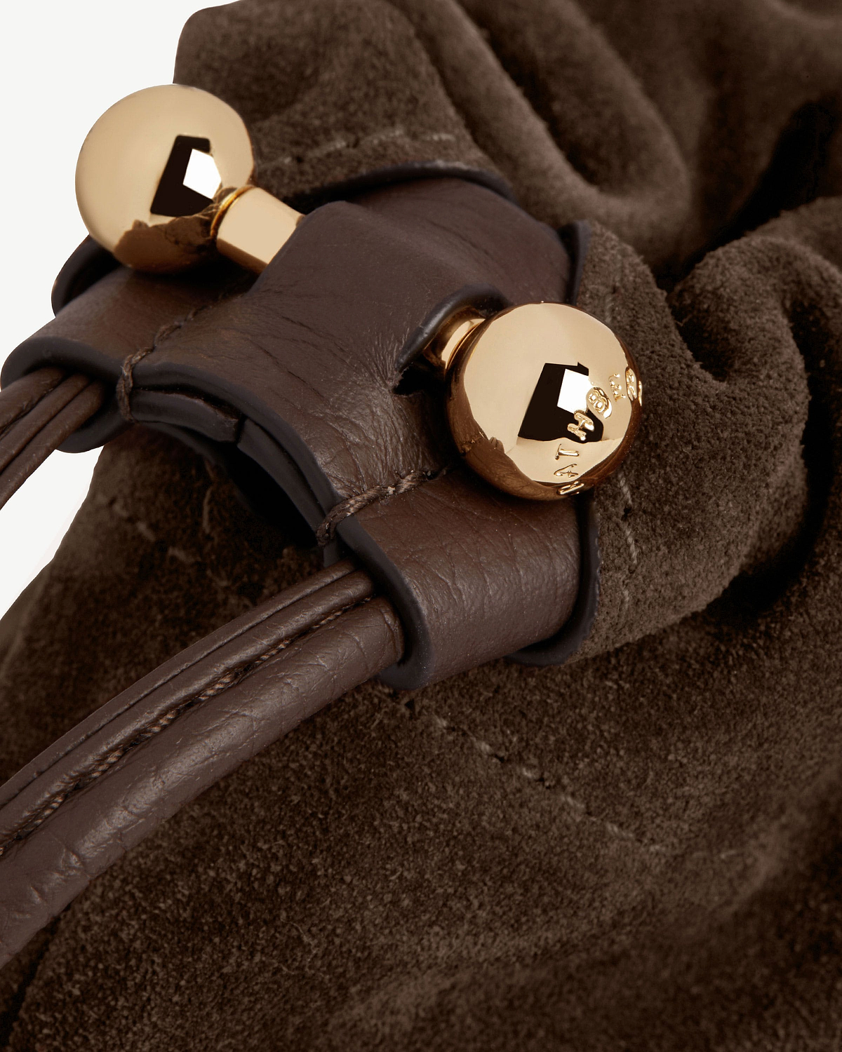 Chocolate suede drawstring bag with leather cord and gold ball toggle hardware.
