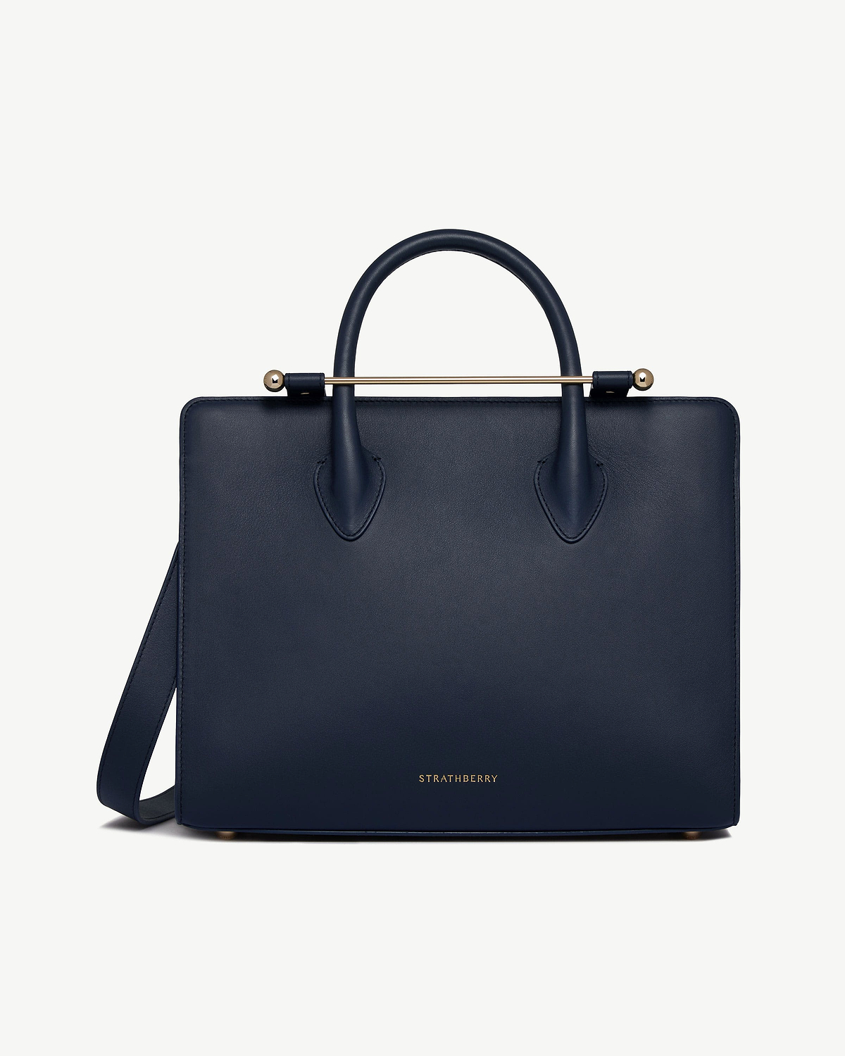 Marine blue leather midi tote with top handles, shoulder strap, and gold Strathberry logo.