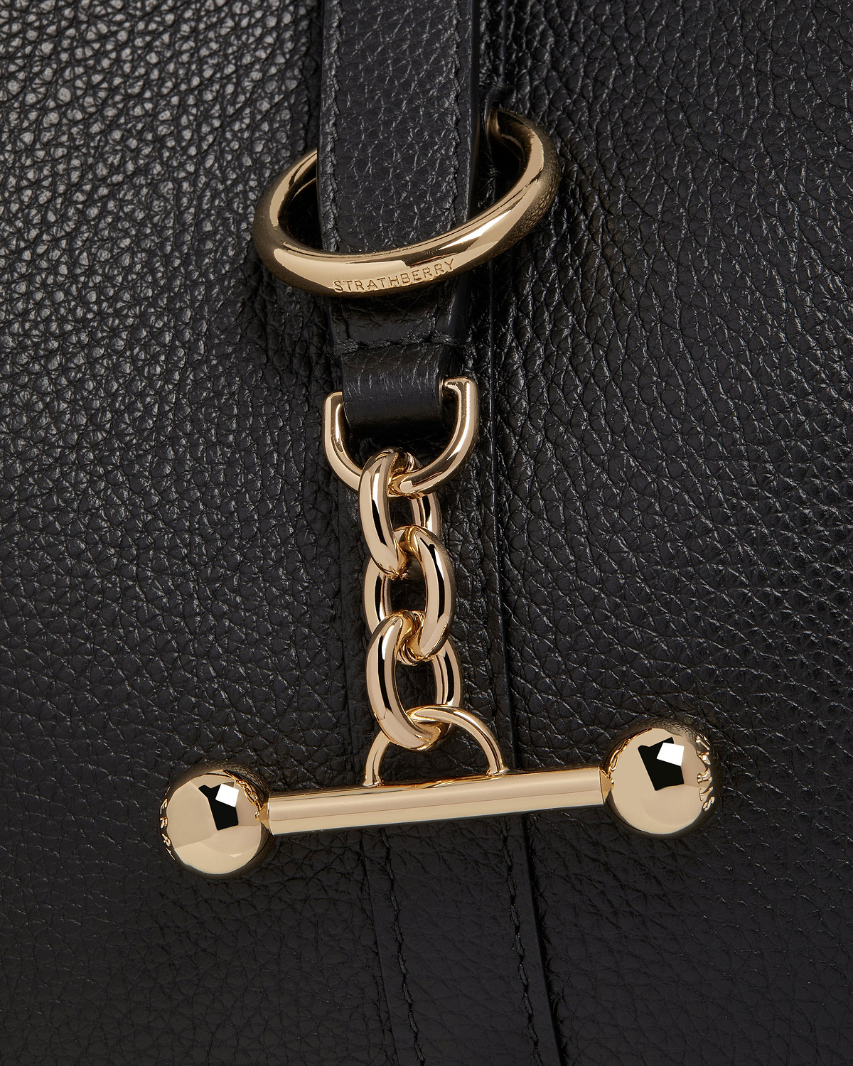 Strathberry Kite Hobo black pebbled leather showing gold chain and bar hardware