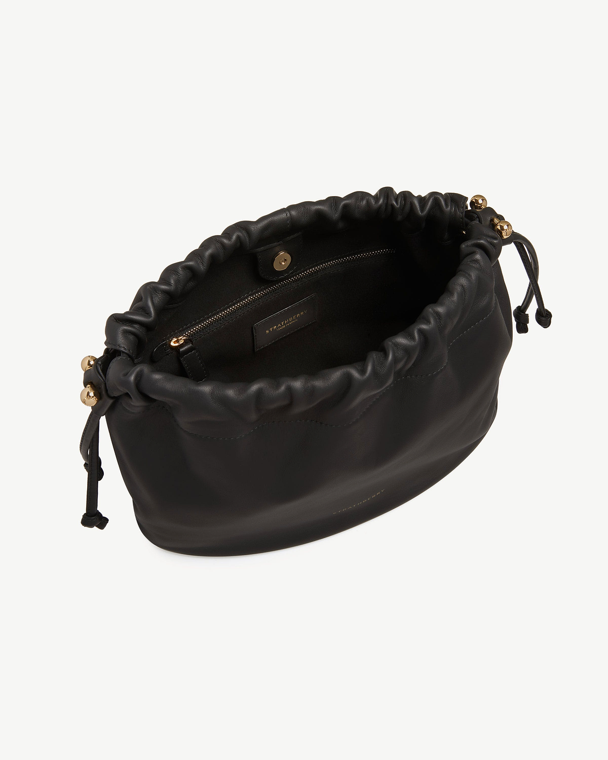 Black Strathberry Charlotte Midi drawstring bag, open top showing interior zip pocket.