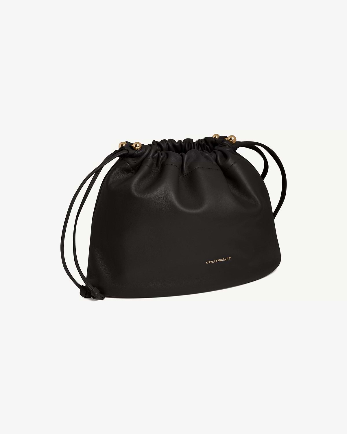 Black Strathberry Charlotte Midi drawstring bag with front logo and gold-tone bead details.