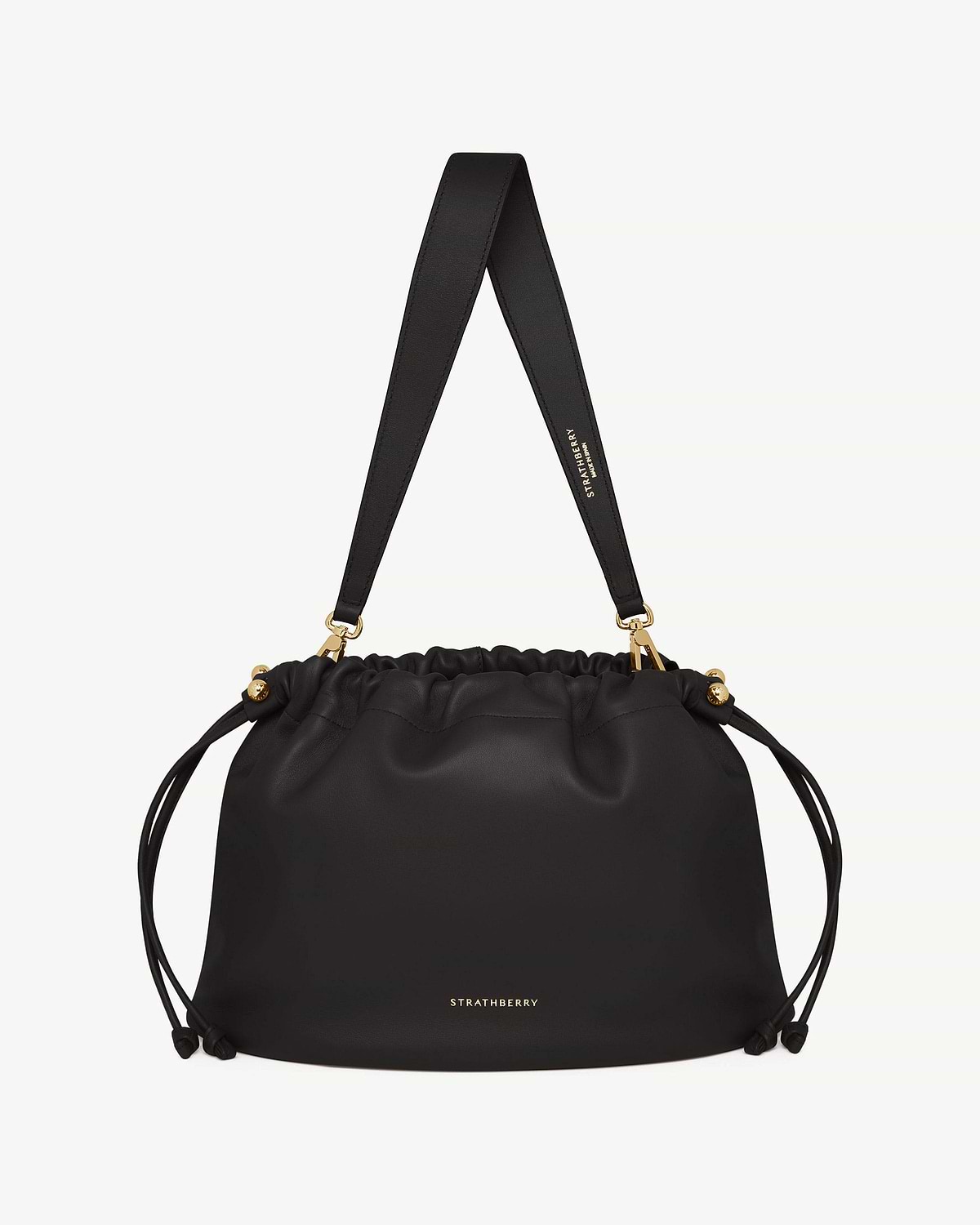 Black Charlotte Midi drawstring bag with wide shoulder strap and gold hardware, Strathberry logo.