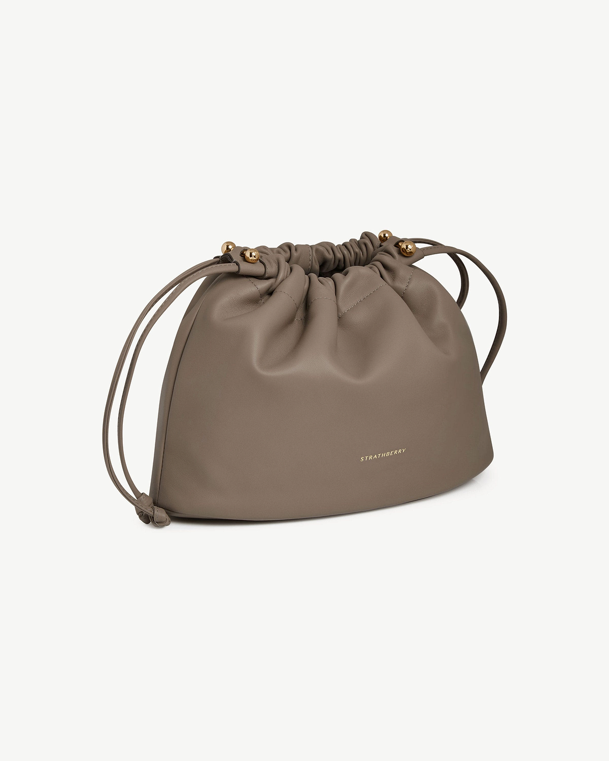 Taupe drawstring leather bag with gold bead ends and Strathberry logo.