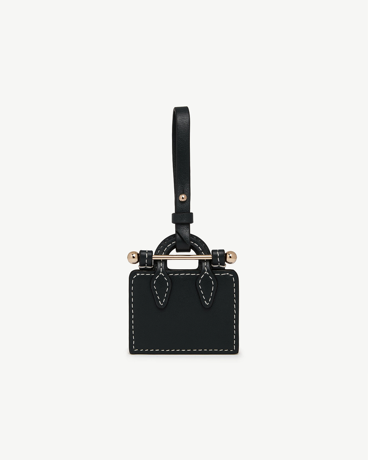 Black tote-shaped charm with white stitching, gold-tone bar and strap loop.