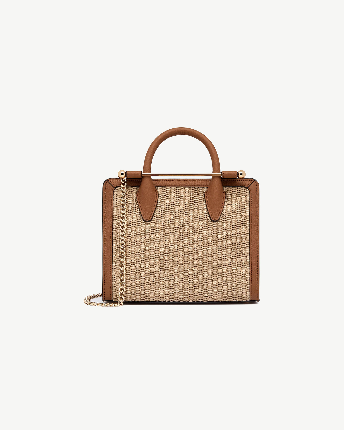 Tan leather-trim mini tote with natural raffia body, top handle and gold chain strap