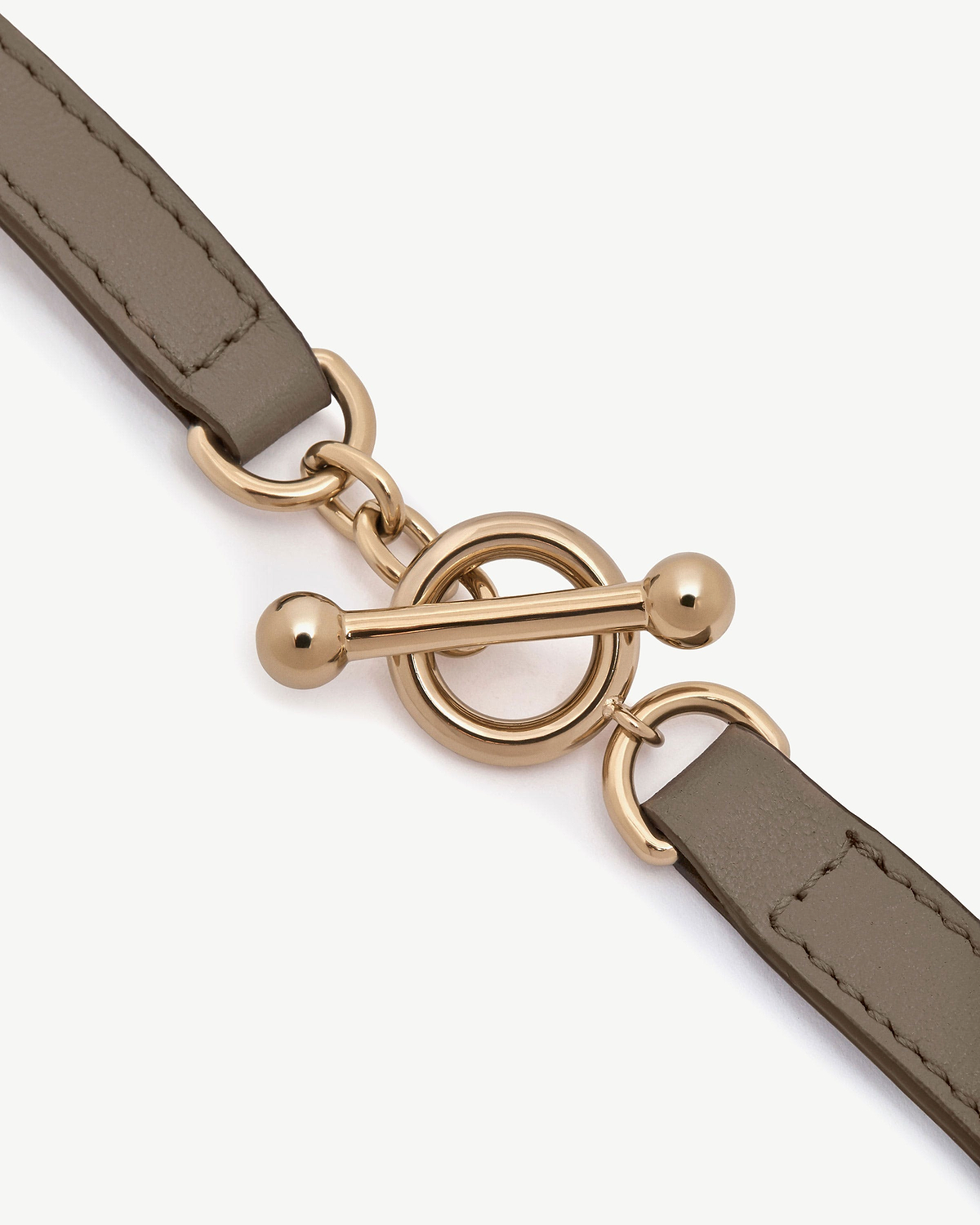 Taupe leather bracelet with gold-tone toggle ring and bar clasp