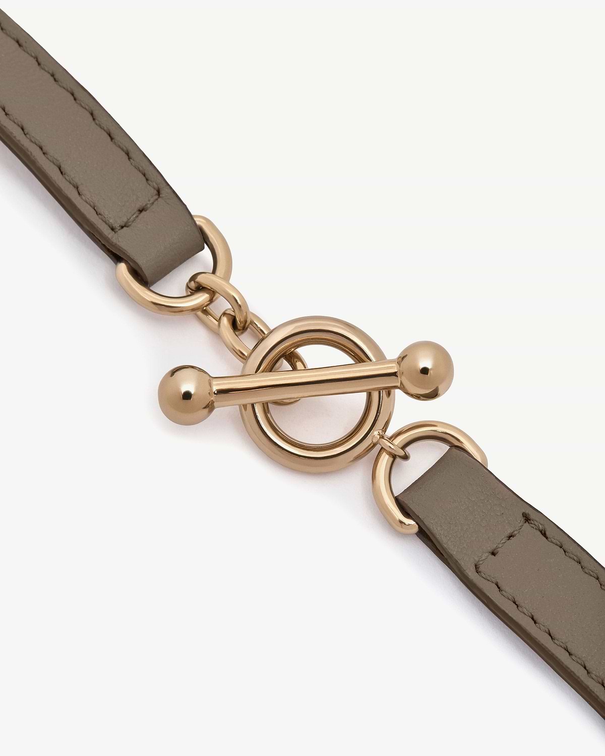 Taupe leather bracelet with gold-tone toggle ring and bar clasp