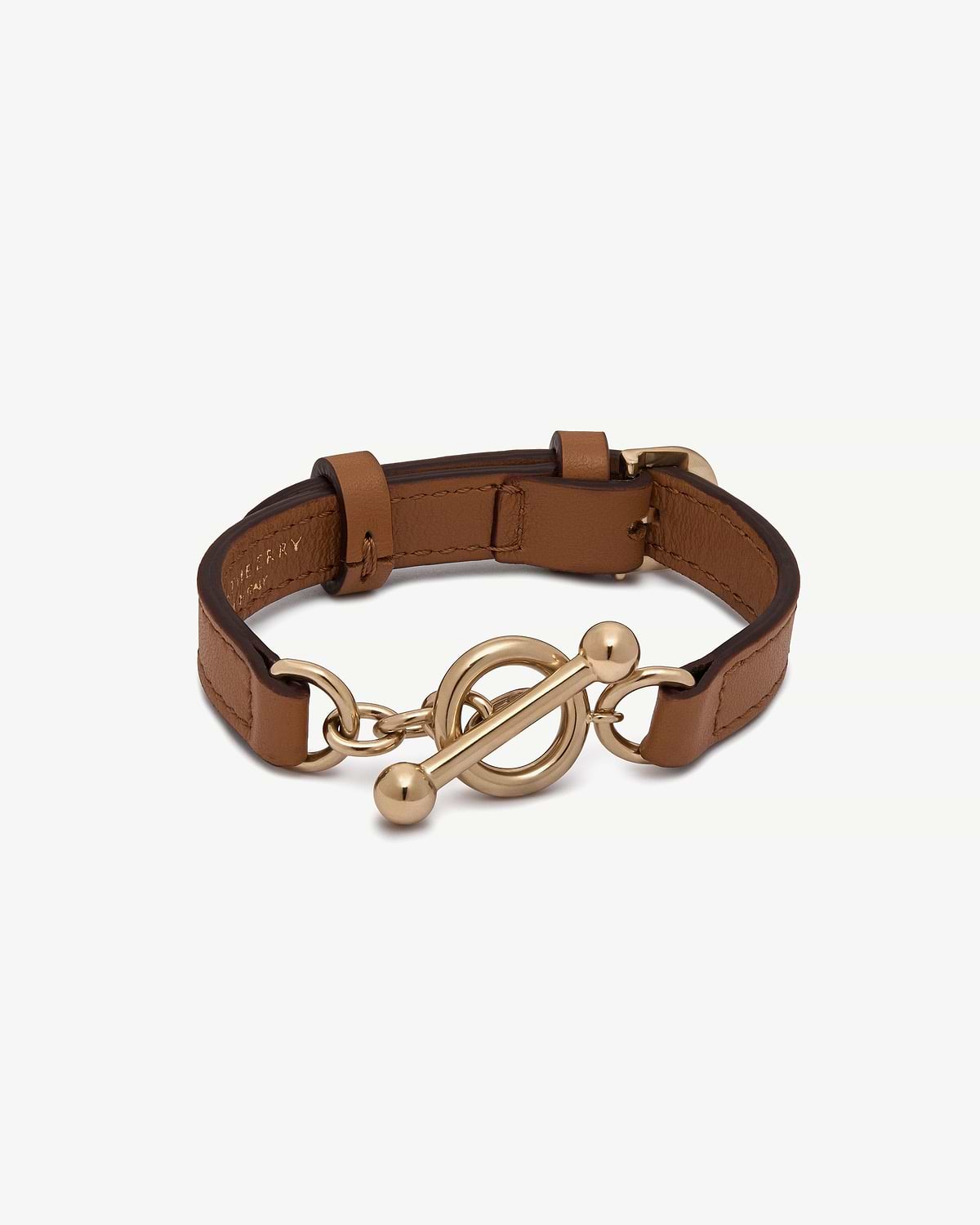 Tan leather bracelet with gold circular toggle clasp and adjustable buckle