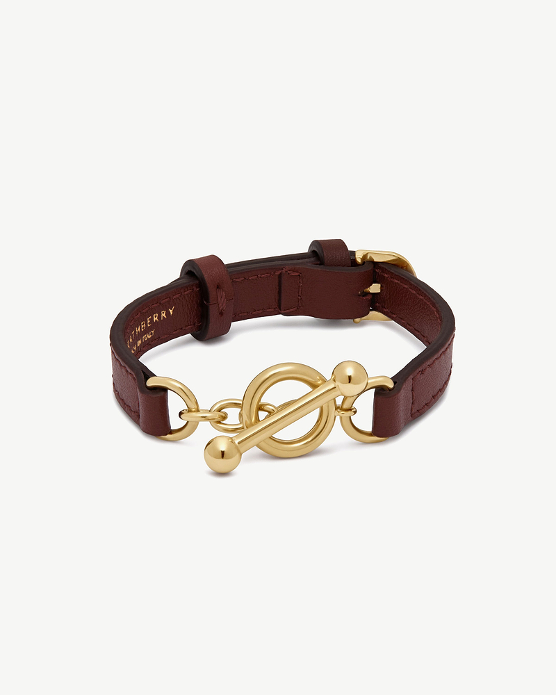 Oxblood leather Kite bracelet with gold toggle clasp, Burberry logo inside.