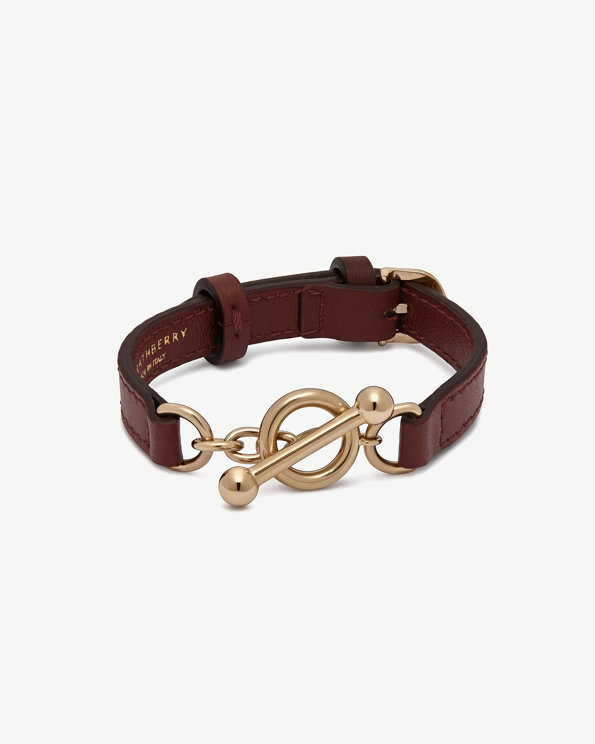 Oxblood leather kite bracelet with gold-tone toggle clasp and adjustable strap.