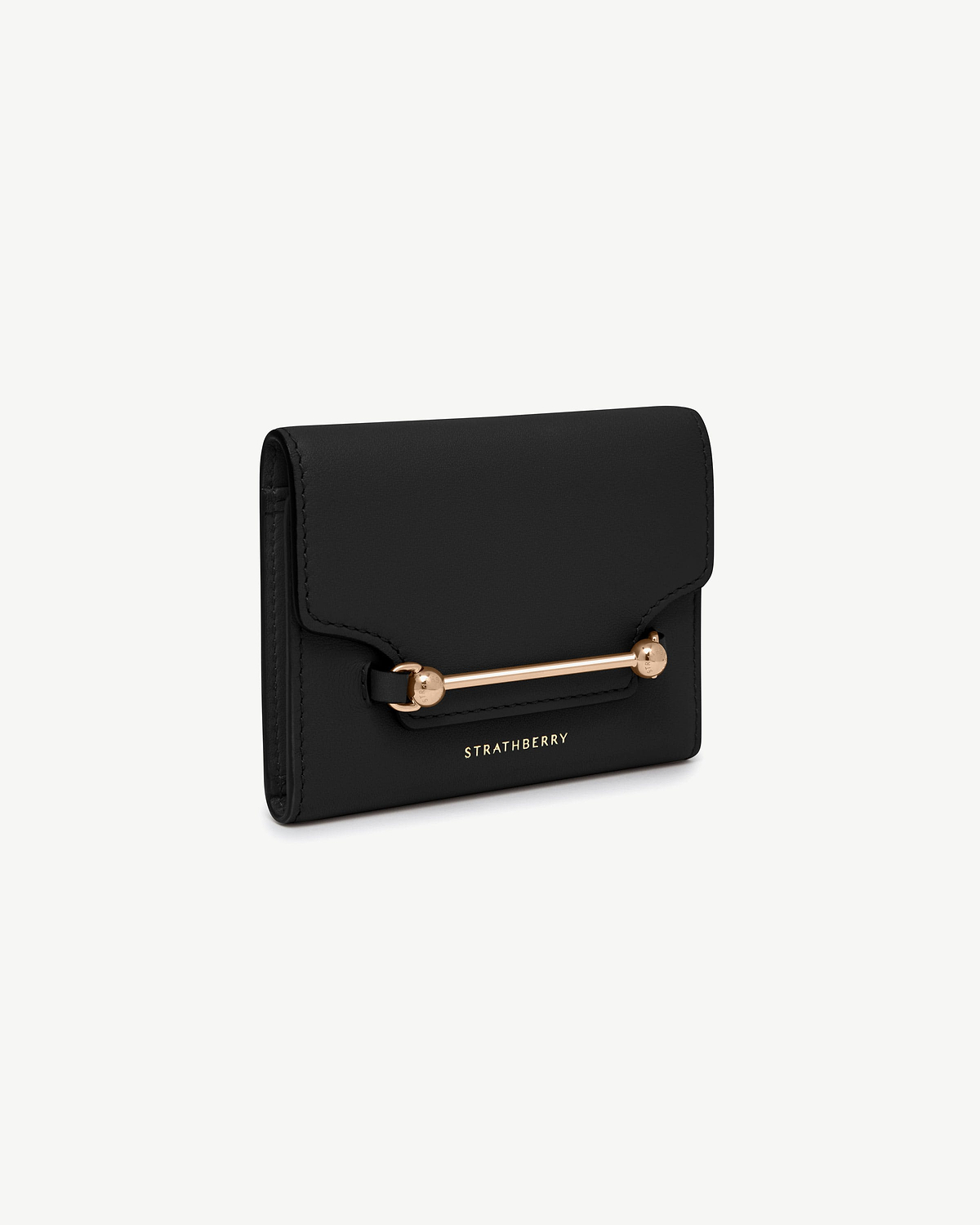 Black Multrees trifold wallet with gold bar hardware and Strathberry logo.