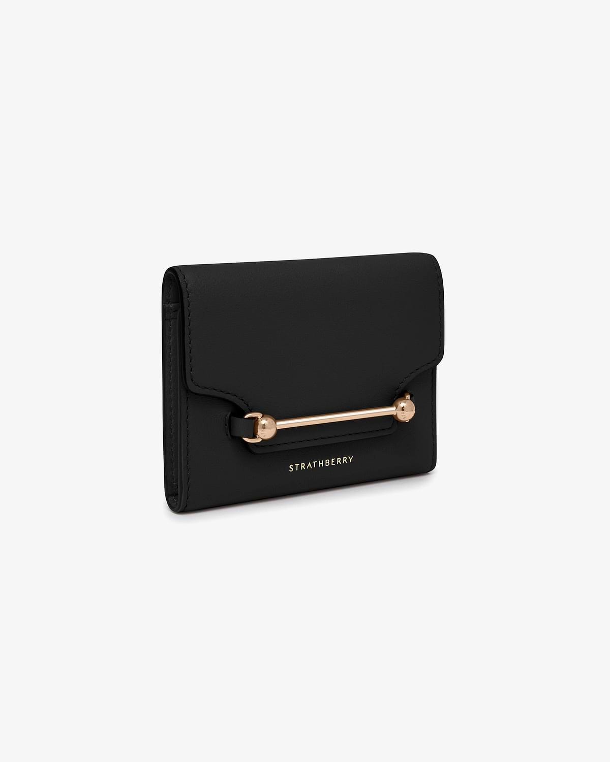 Black Multrees trifold wallet with gold bar hardware and Strathberry logo.