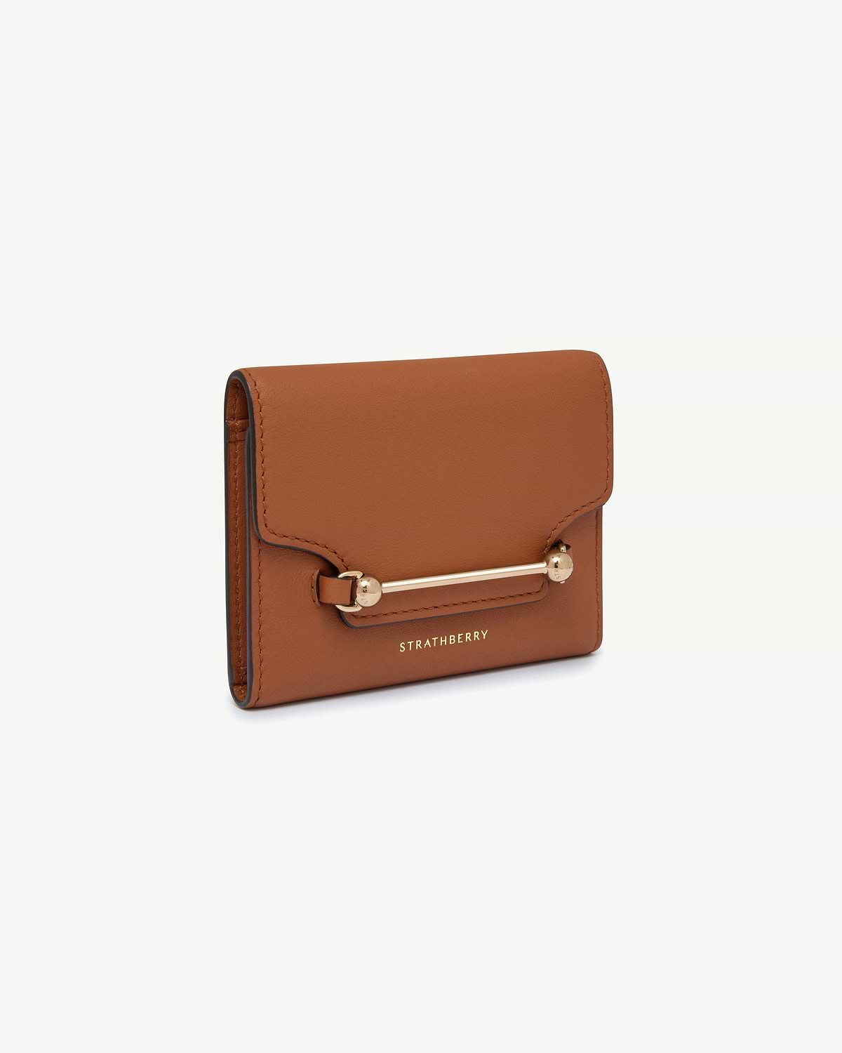 Strathberry chestnut trifold wallet with gold bar fastener on white background.