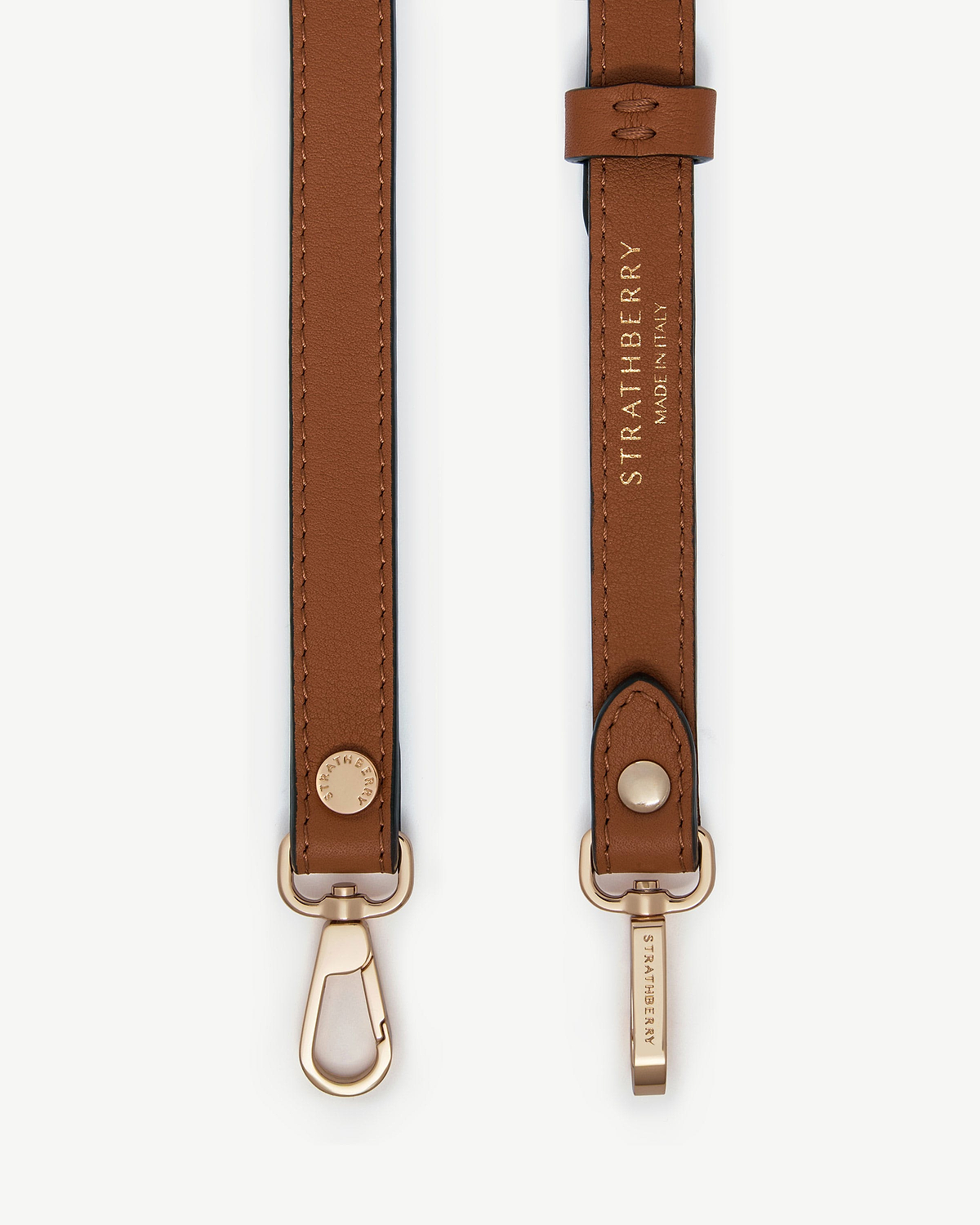 Chestnut thin adjustable leather strap with gold hardware and Strathberry logo.