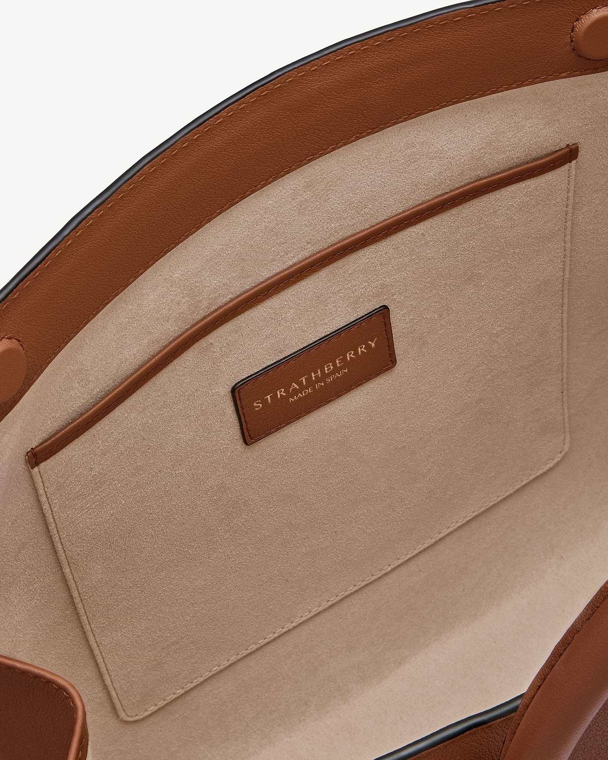 Chestnut leather-trimmed tote interior with suede lining and Strathberry leather label.