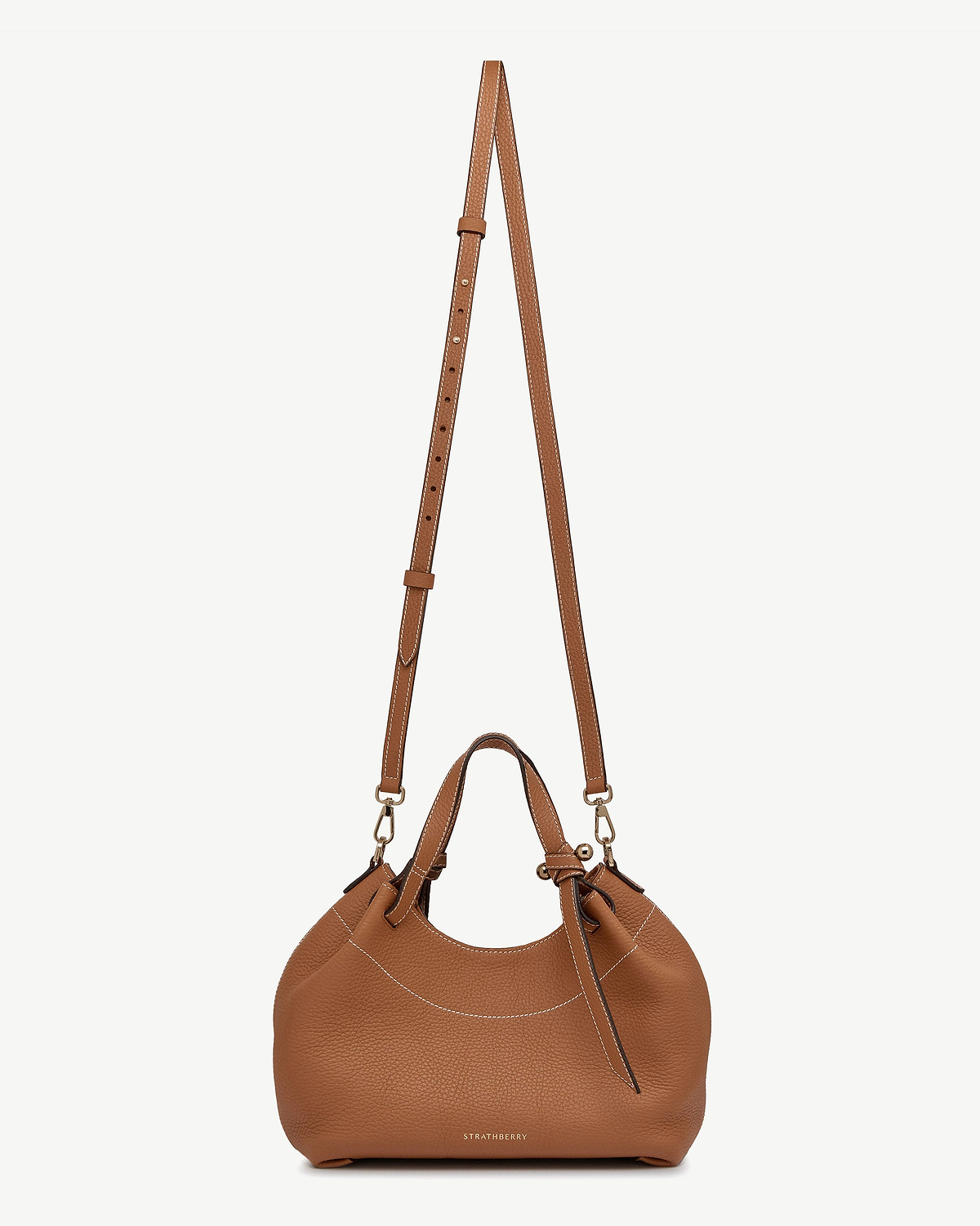 Tan leather Barra Mini bag with top handle, detachable strap, Strathberry logo.