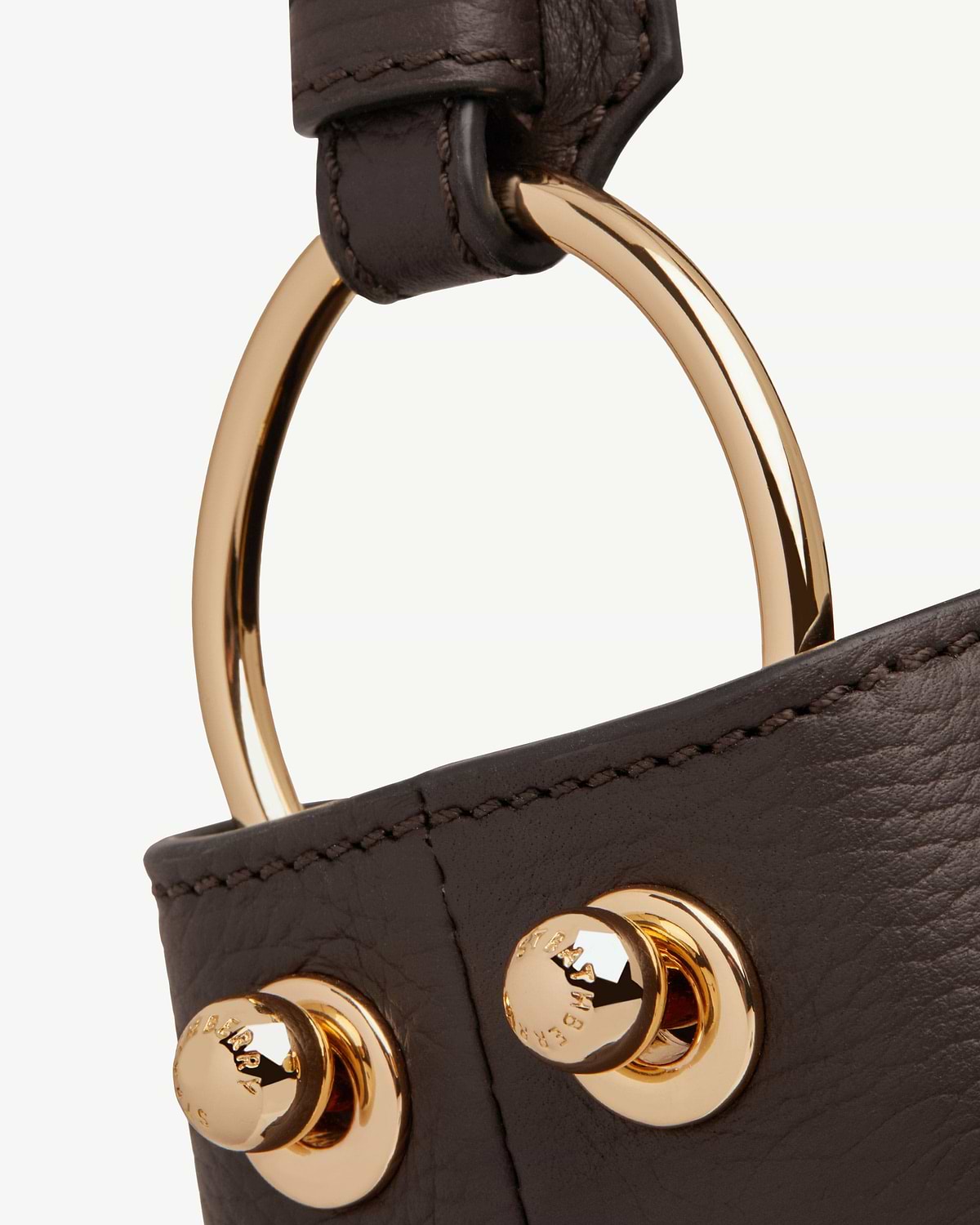 Strathberry Lana Hobo espresso leather strap showing gold ring hardware and stitched seam
