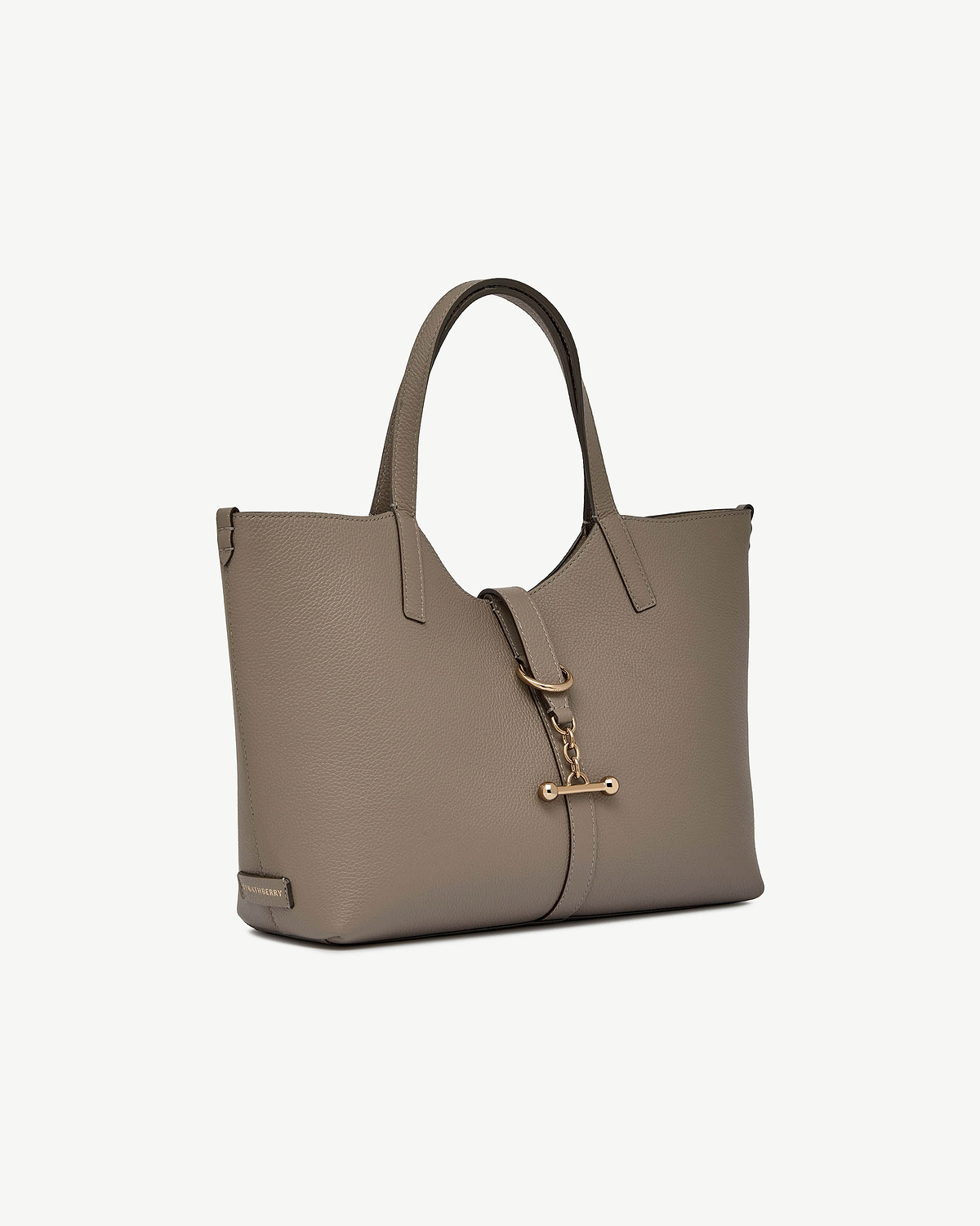 Taupe leather tote bag with top handles and gold bar strap closure.
