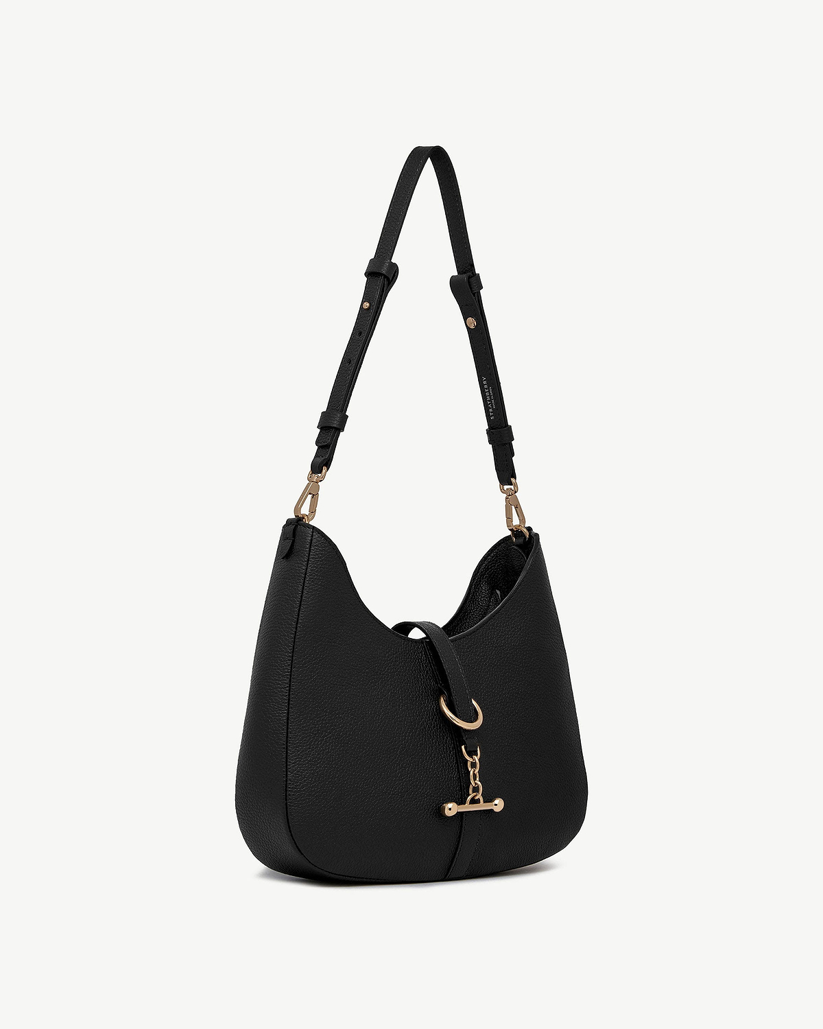 Black leather kite sling bag with gold hardware and adjustable shoulder strap.