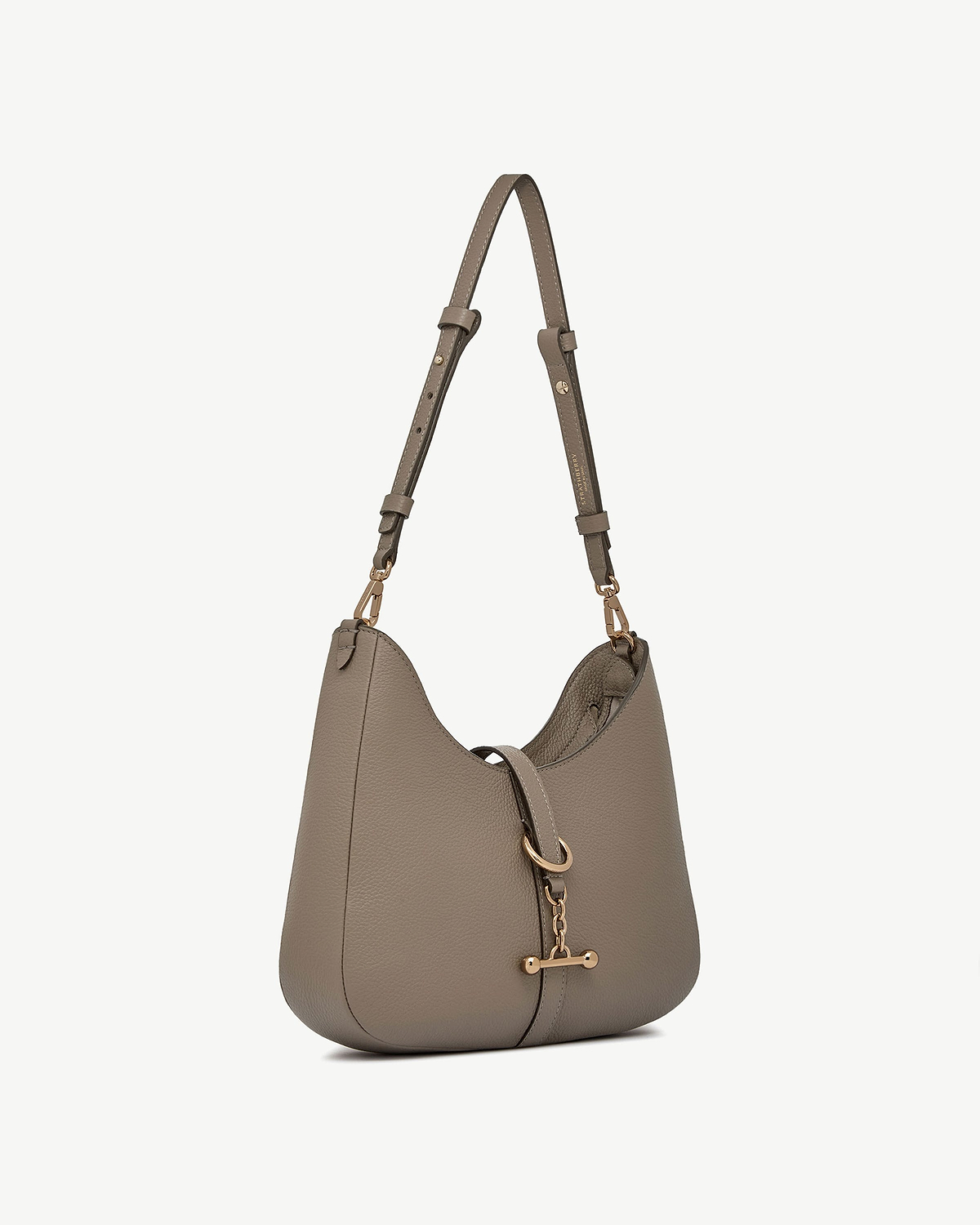 Taupe leather kite sling bag with gold hardware and adjustable shoulder strap