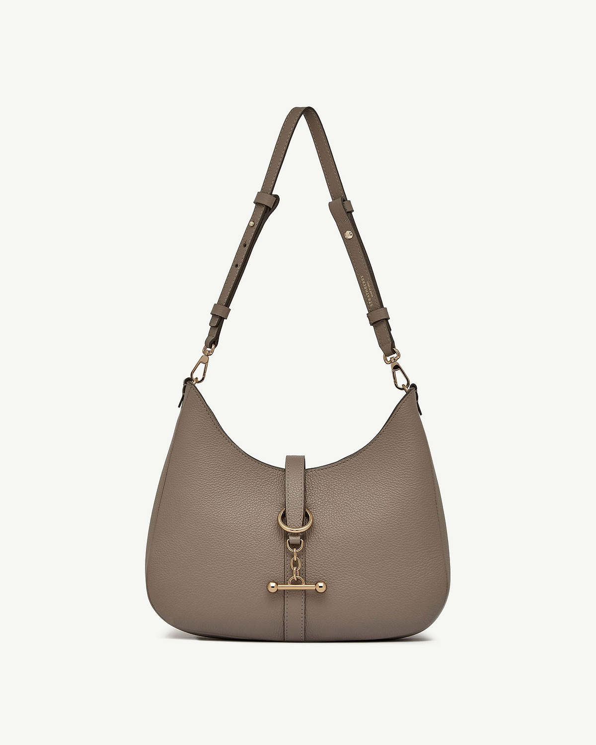 Taupe pebbled leather kite sling bag with adjustable strap and gold bar hardware.