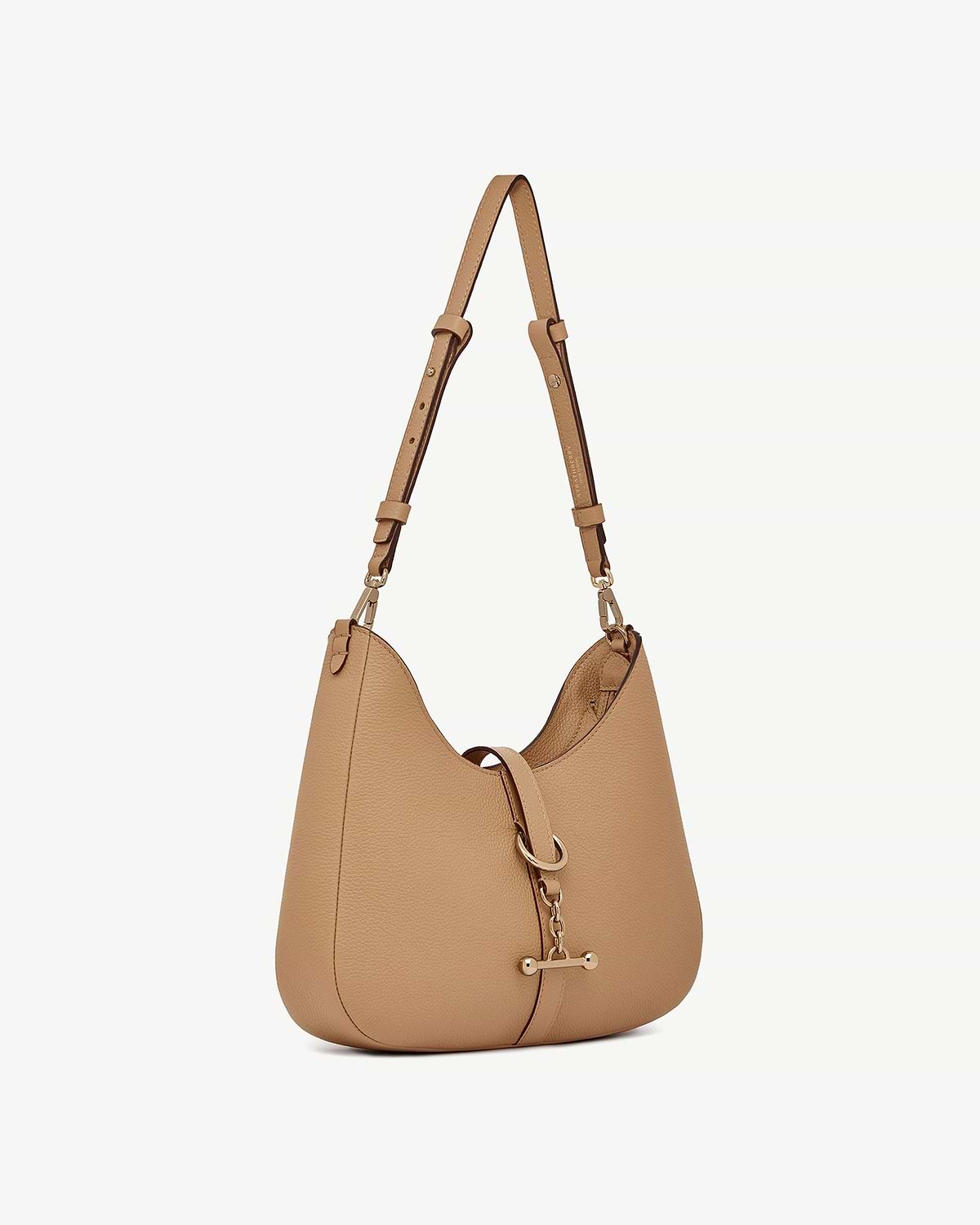 Caramel leather kite sling bag with single adjustable strap and metal clasp.