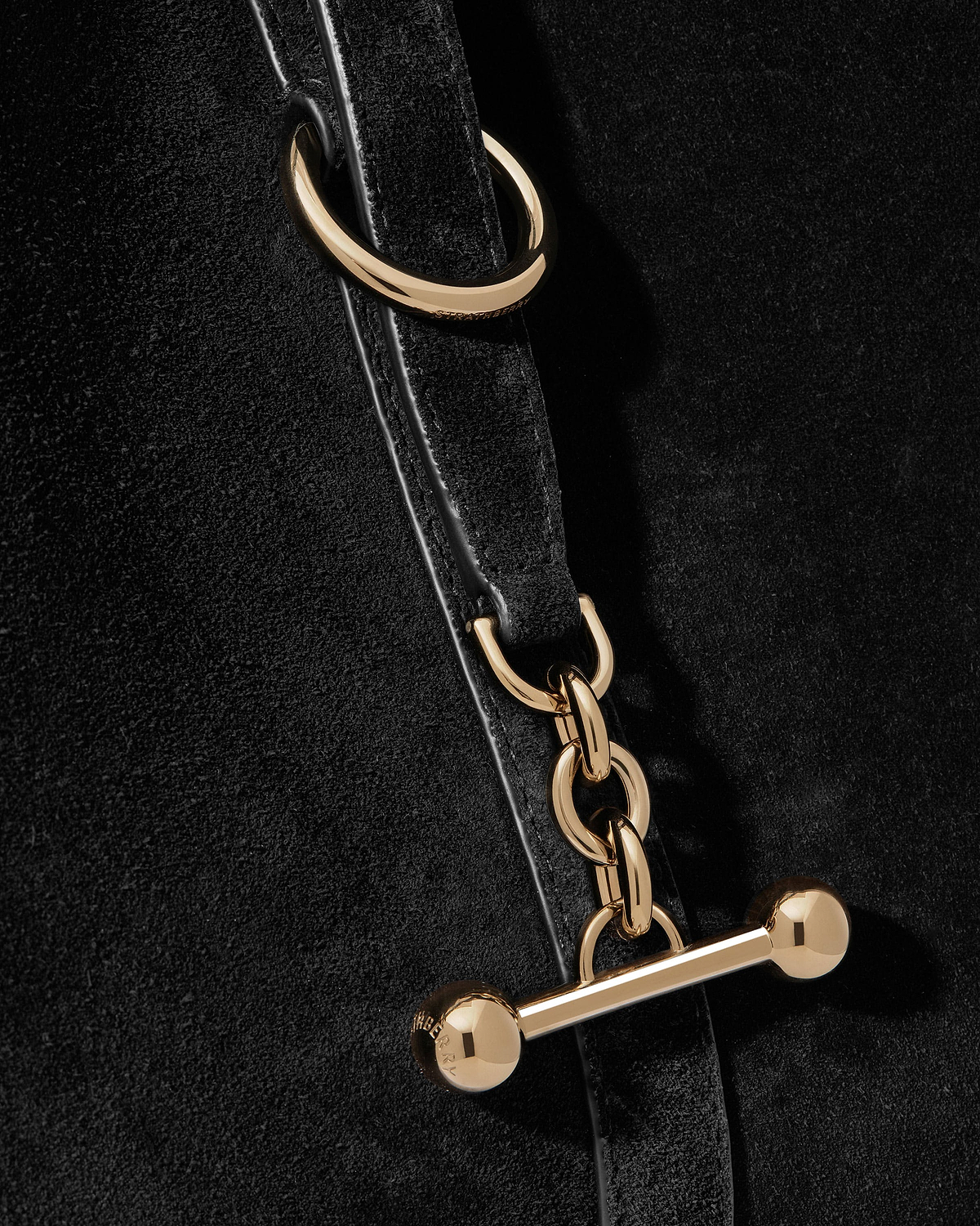 Black suede strap with gold chain links and bar toggle hardware.
