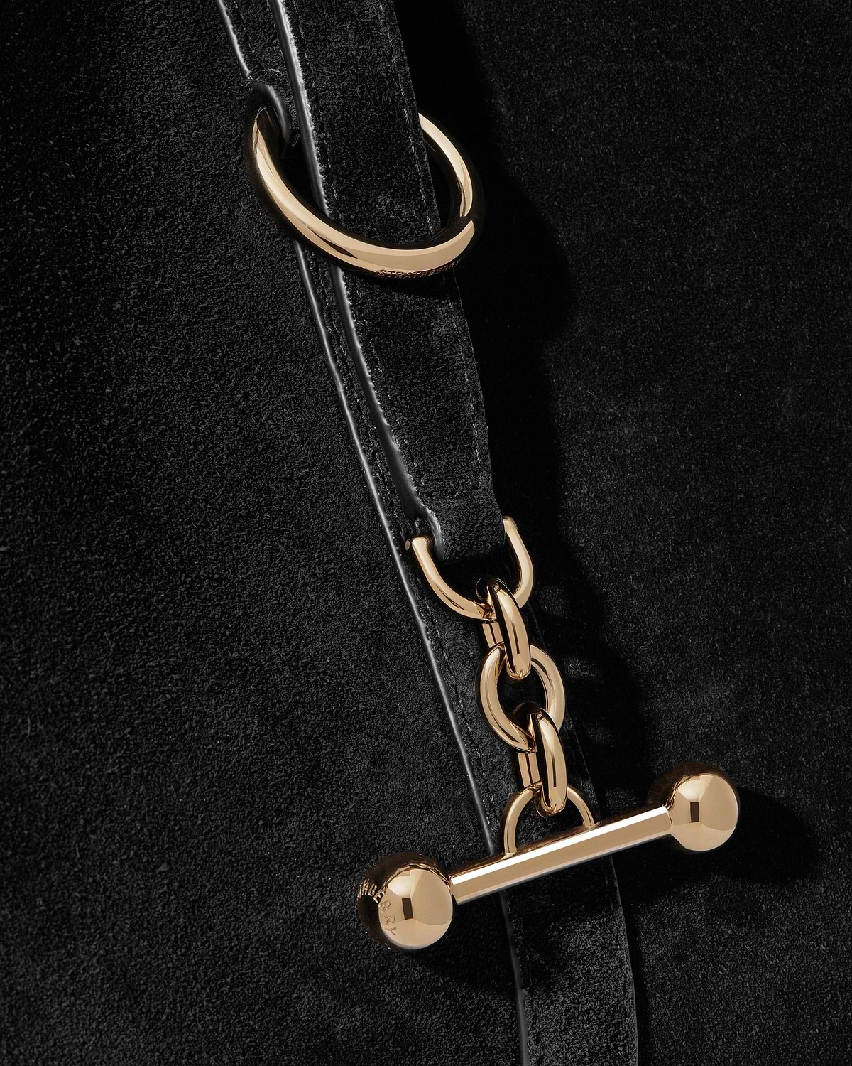 Black suede strap with gold chain links and bar toggle hardware.