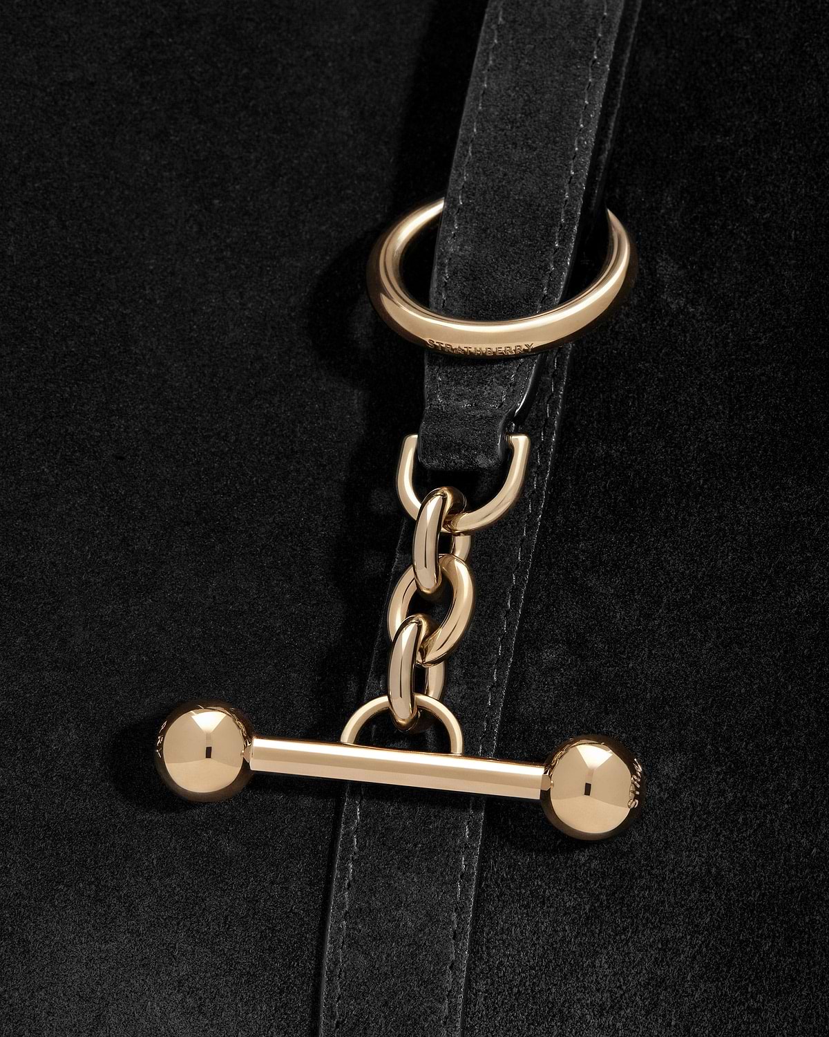 Black suede Kite Hobo strap with gold chain, toggle and Strathberry ring.