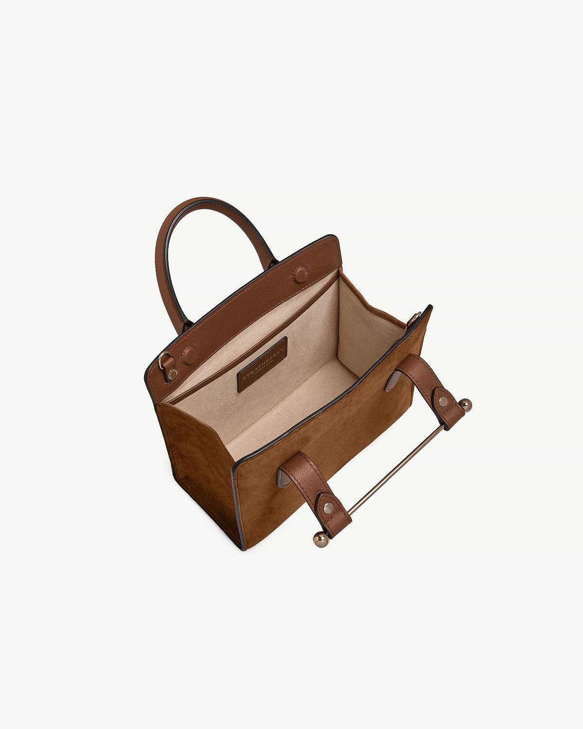 Tan suede mini tote open with leather handles, beige interior and Strathberry label.