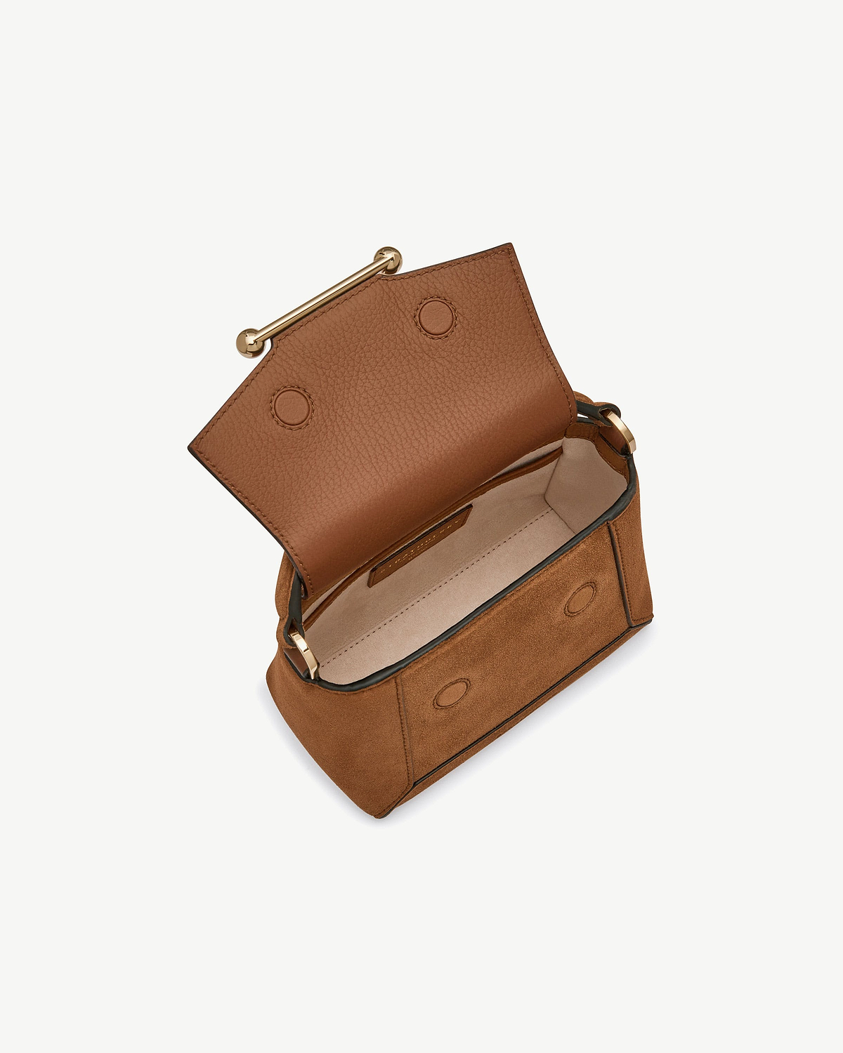 Tan suede mini bag open, showing leather flap, interior and gold bar.