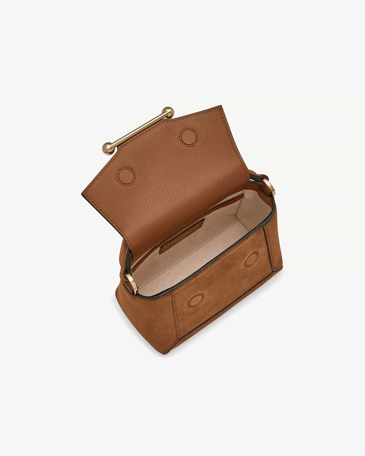Tan suede mini bag open, showing leather flap, interior and gold bar.