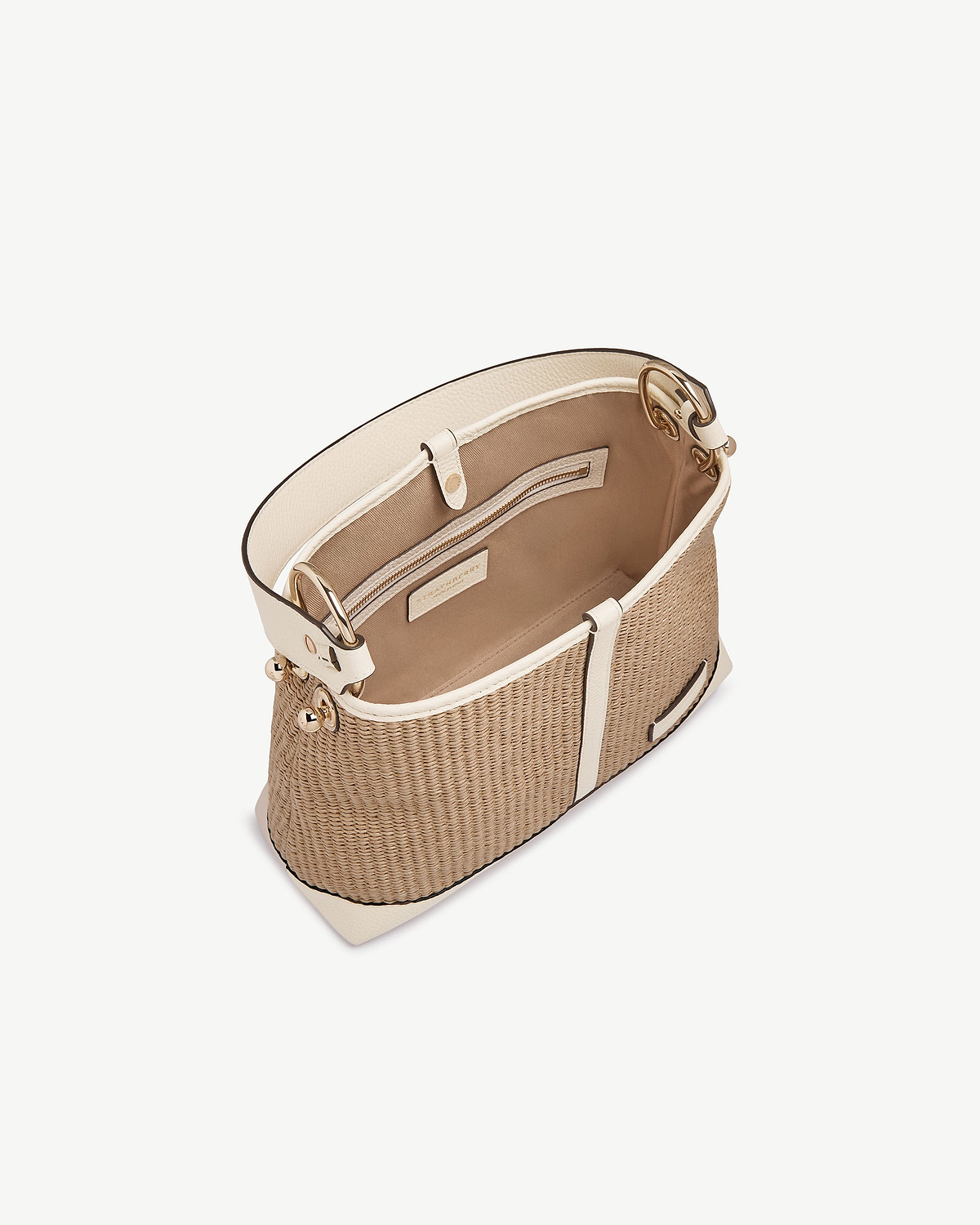 Top view of a vanilla and natural raffia Lana hobo bag showing interior pocket