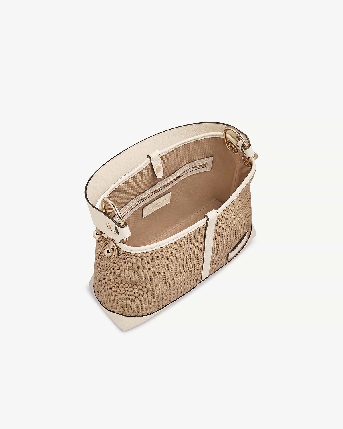 Top view of a vanilla and natural raffia Lana hobo bag showing interior pocket