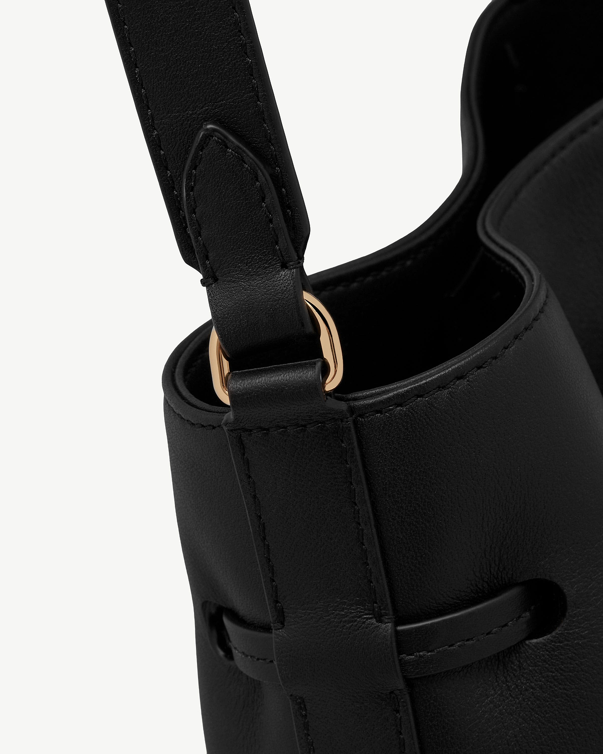 Black leather bucket bag strap and gold-tone ring with stitched detailing.