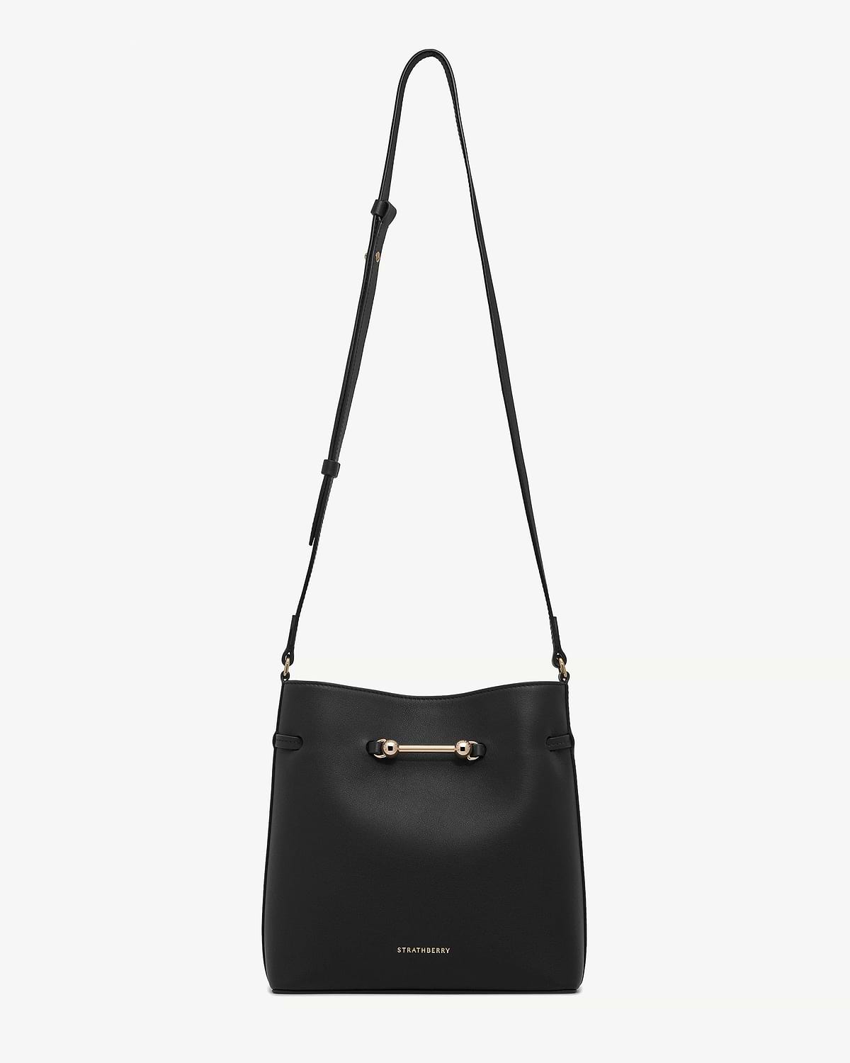 Black Corda bucket bag with adjustable shoulder strap, gold bar hardware, Strathberry logo.