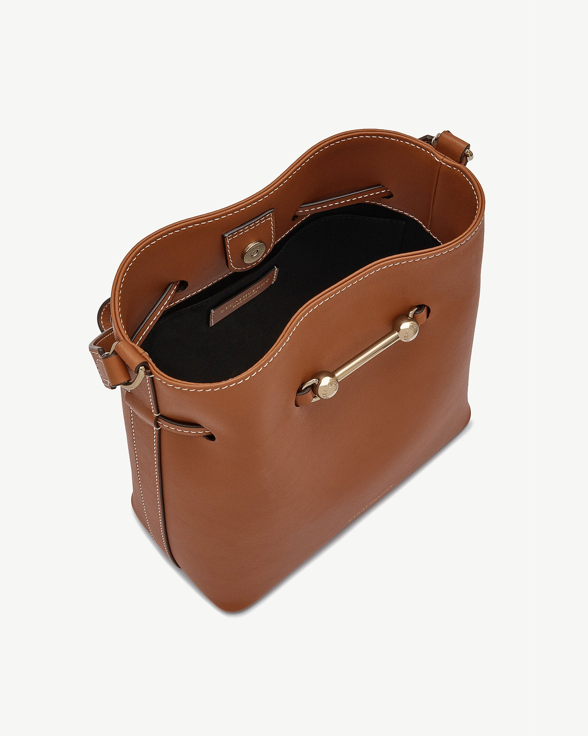 Chestnut leather bucket bag with white topstitching, black lining and gold bar hardware.