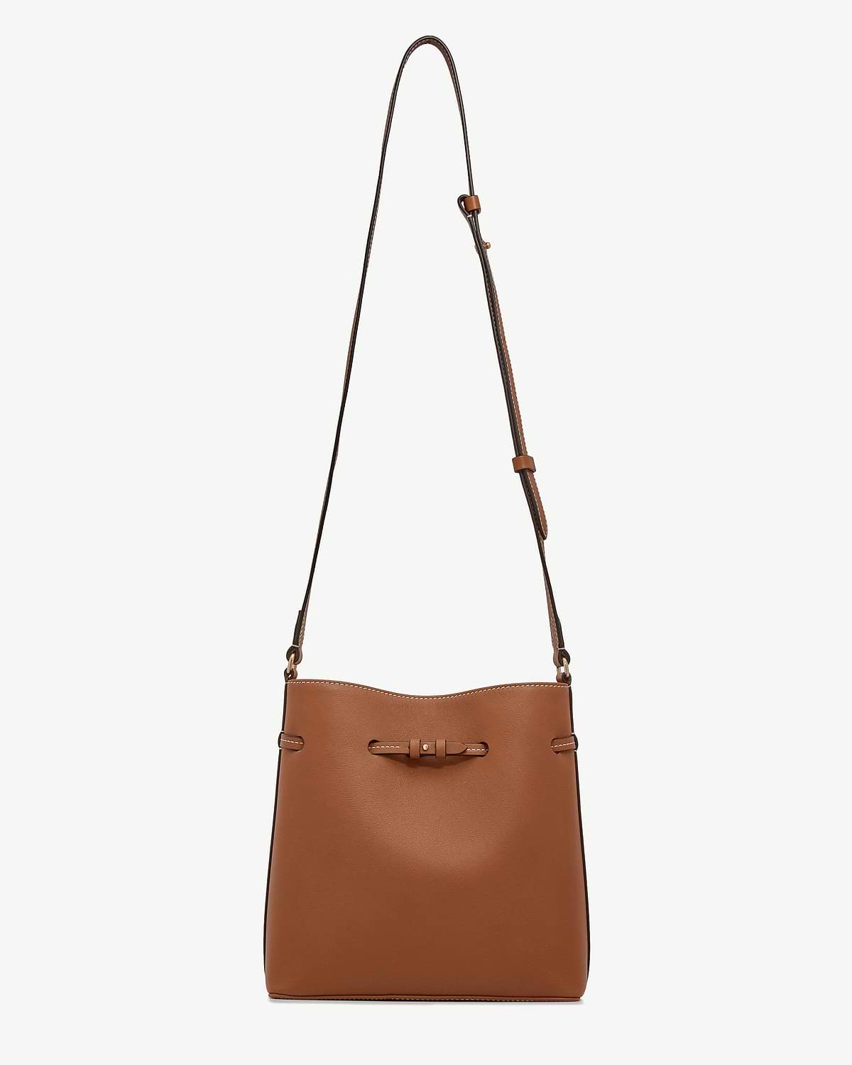 Chestnut leather bucket bag with long adjustable strap and knotted front detail.