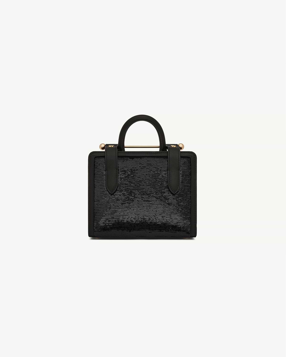 Black sequin nano tote with top handles and gold bar detail.
