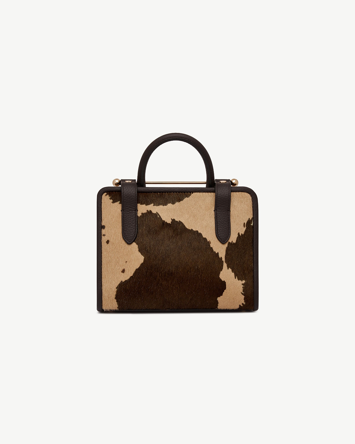 Mini tote in sand and espresso spot print with dark brown handles.