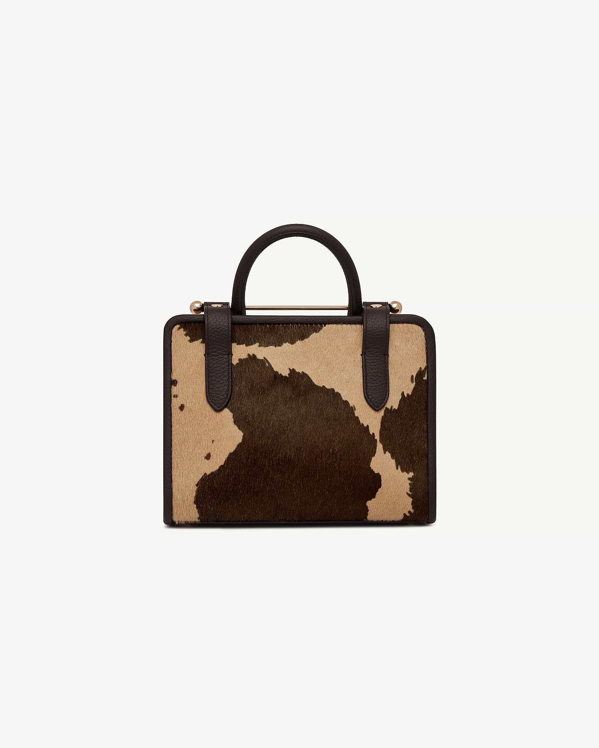 Mini tote in sand and espresso spot print with dark brown handles.